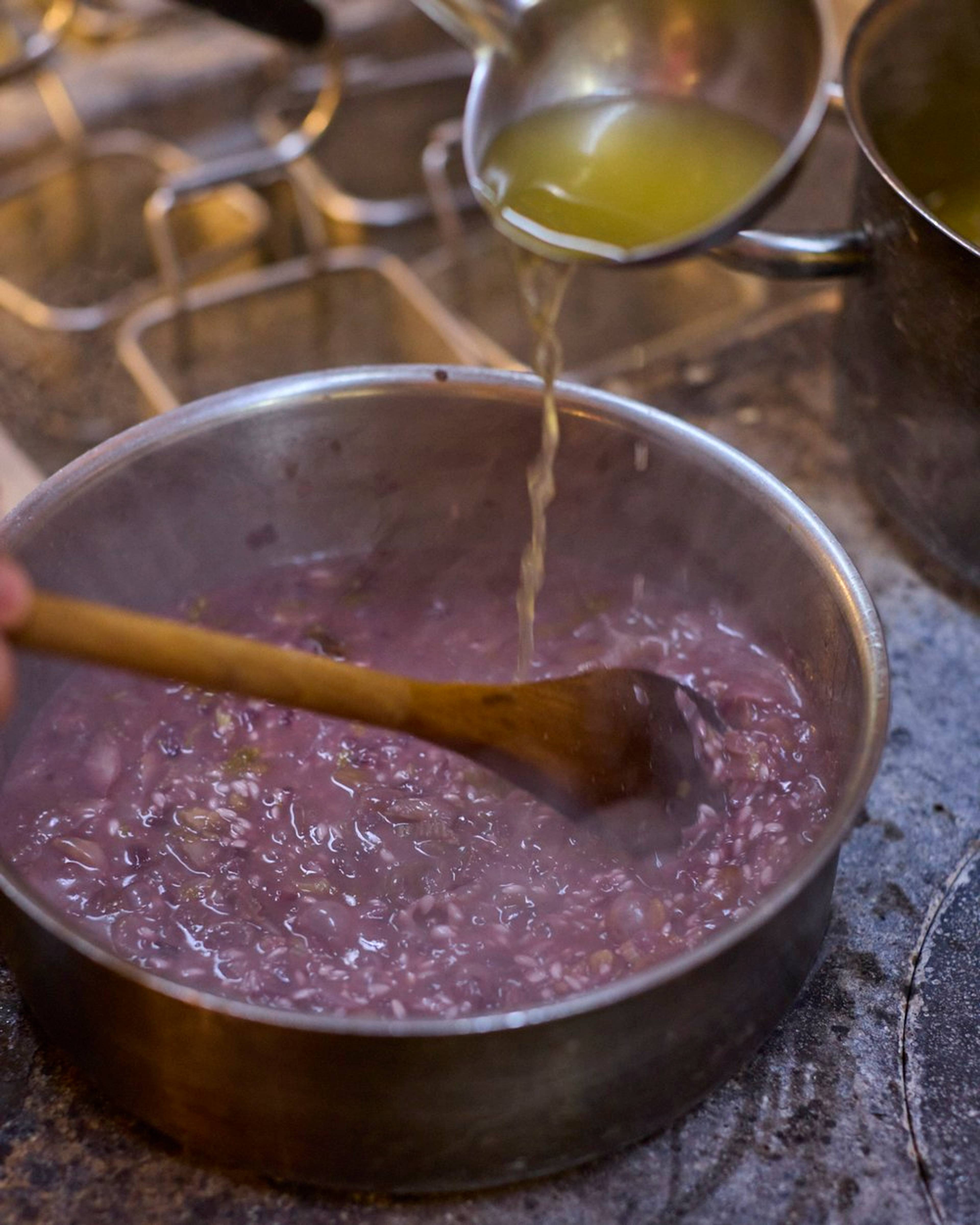 pouring stock in the risotto