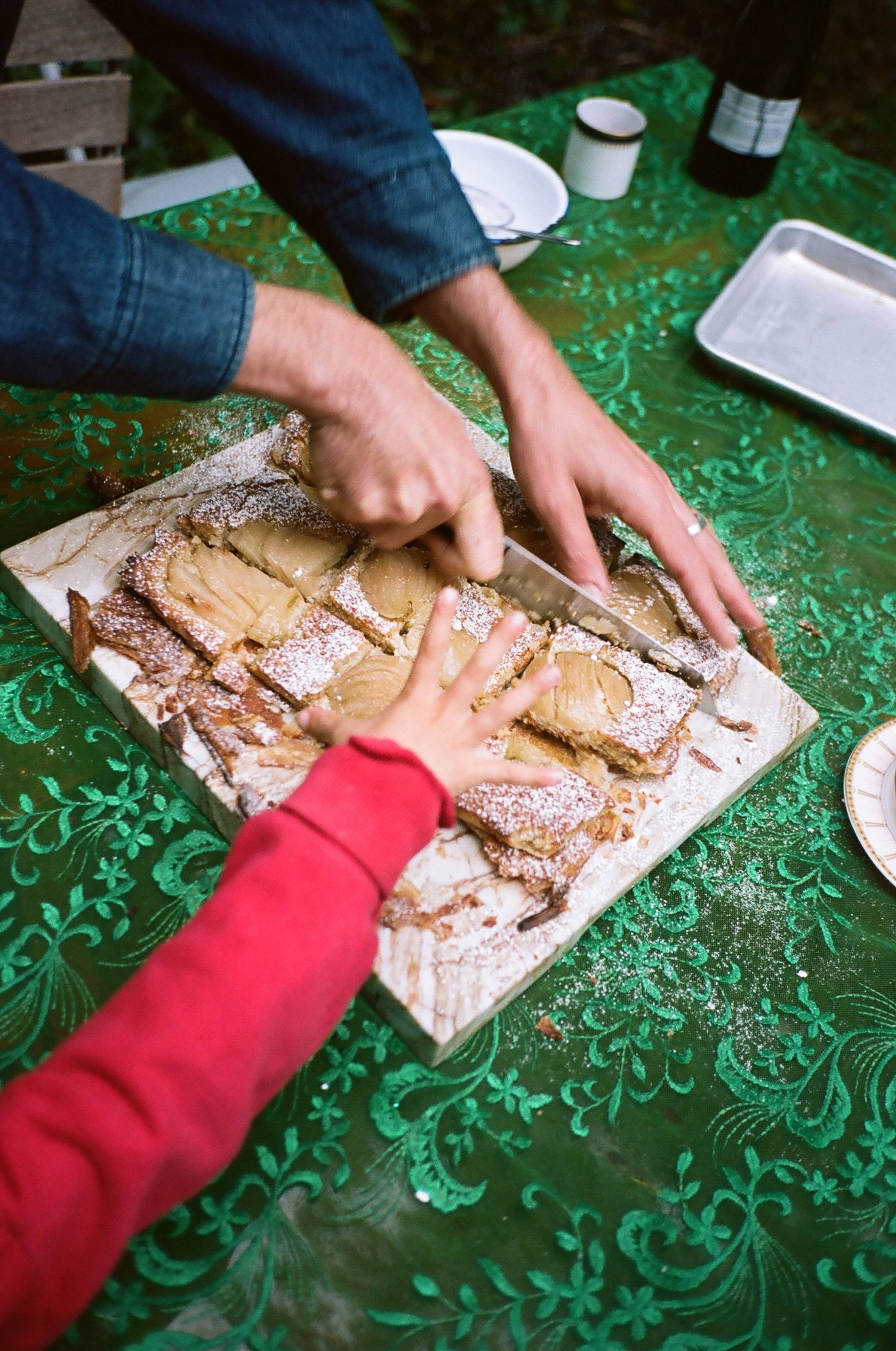 kids hand going to grab a slice of pear tart