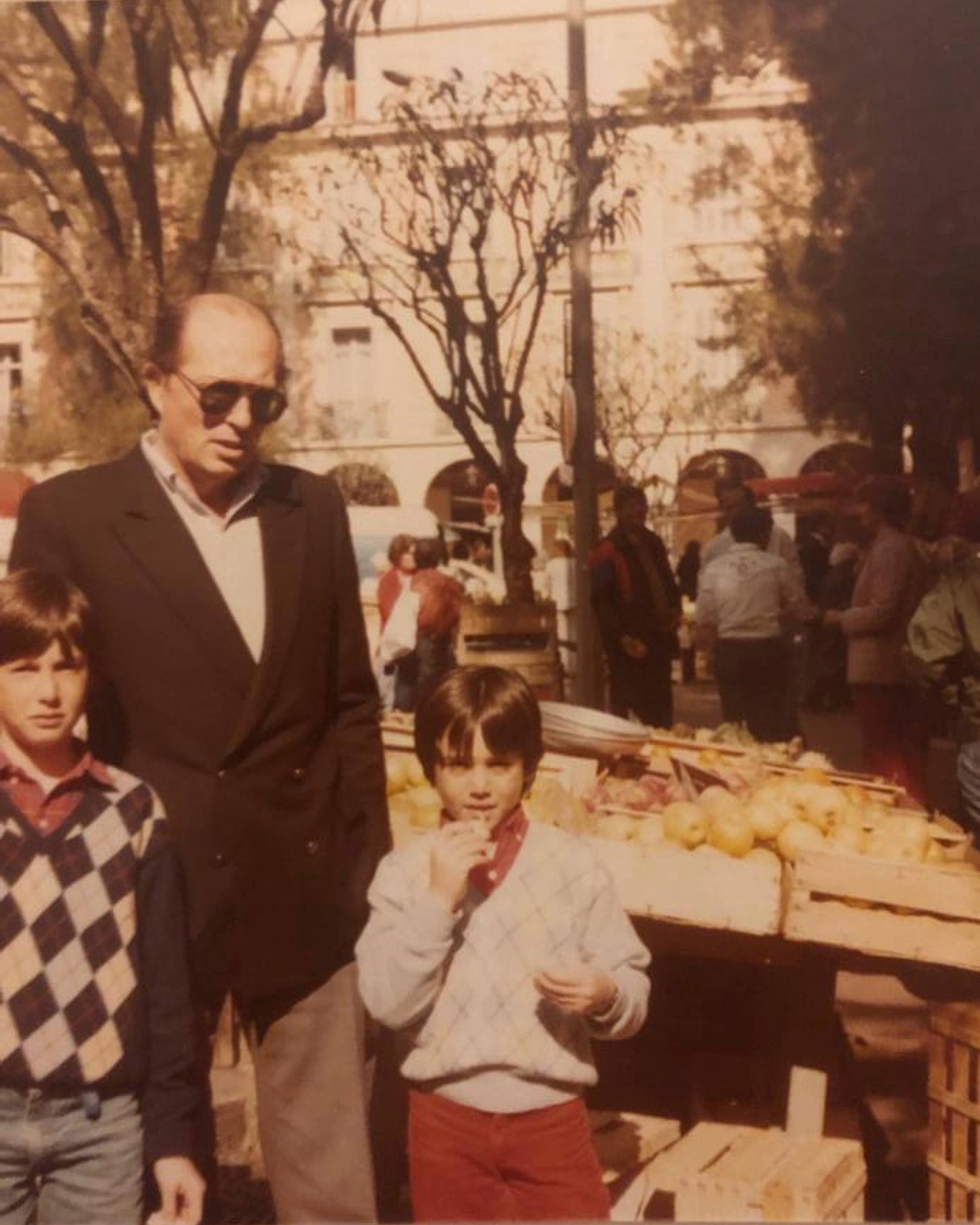 Photograph of Franco as a child at a market with his step-father and brother