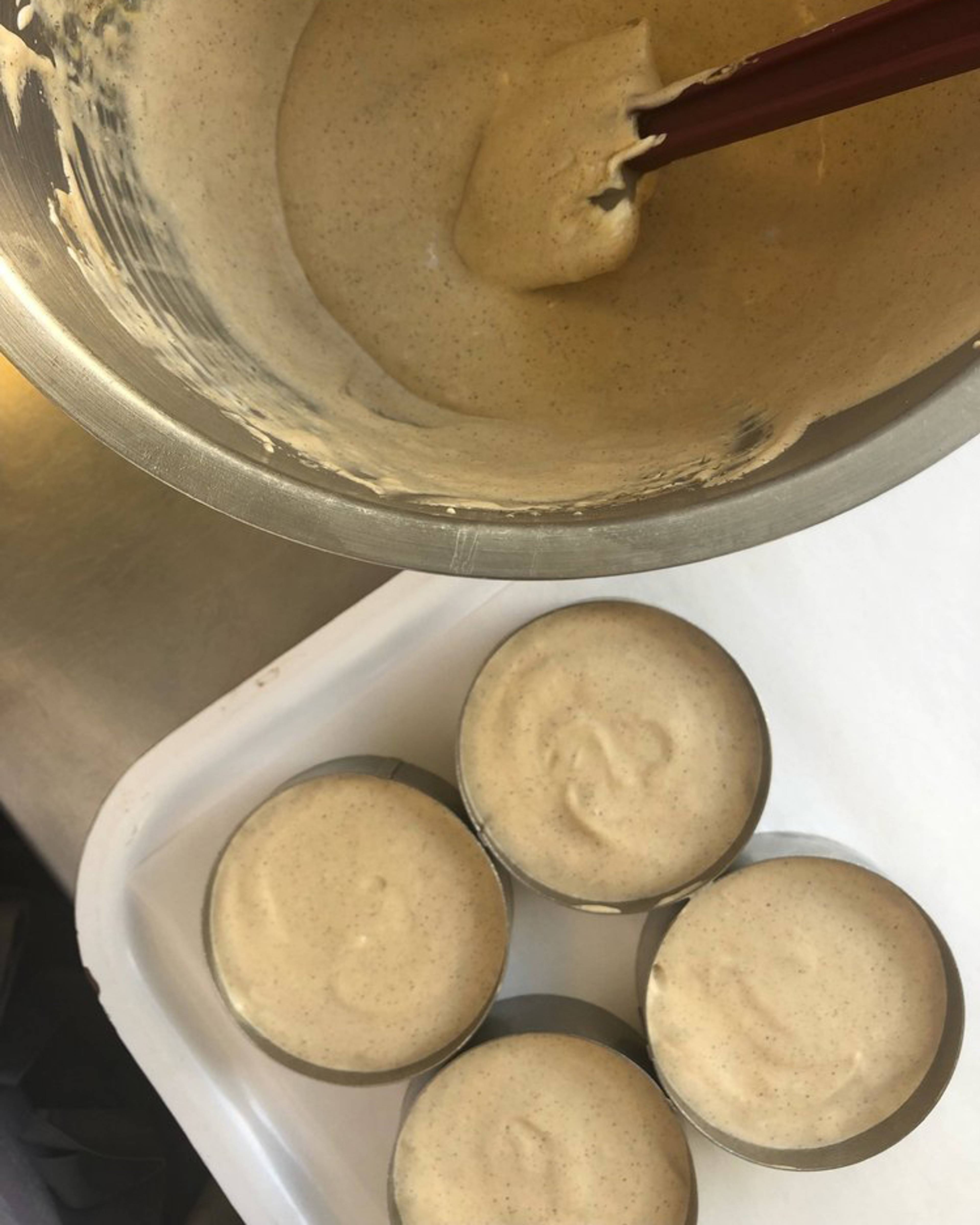 Semifreddo mix being divided into ramekins