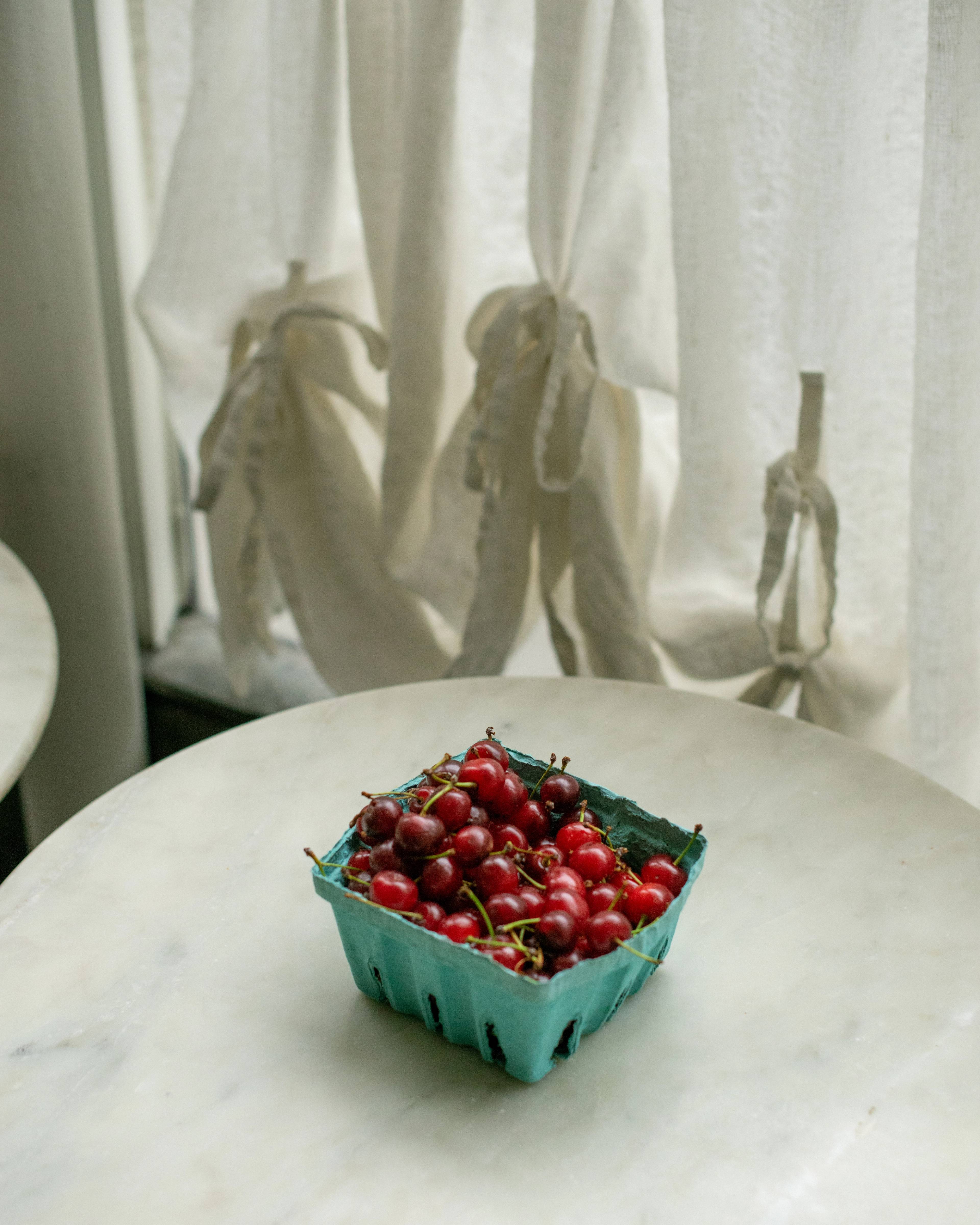 Pint of Sour Cherries on white table