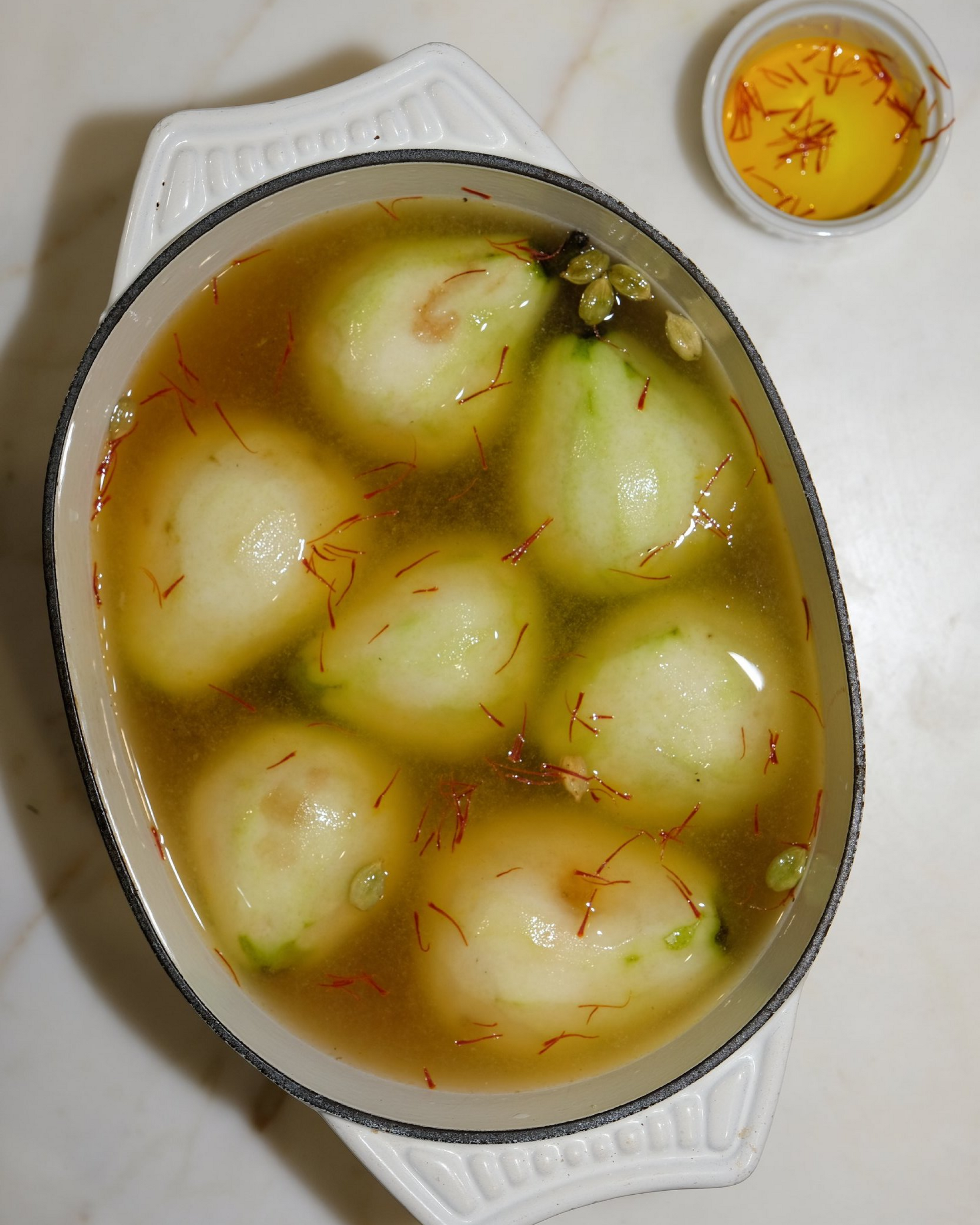 pears poaching in the liquid