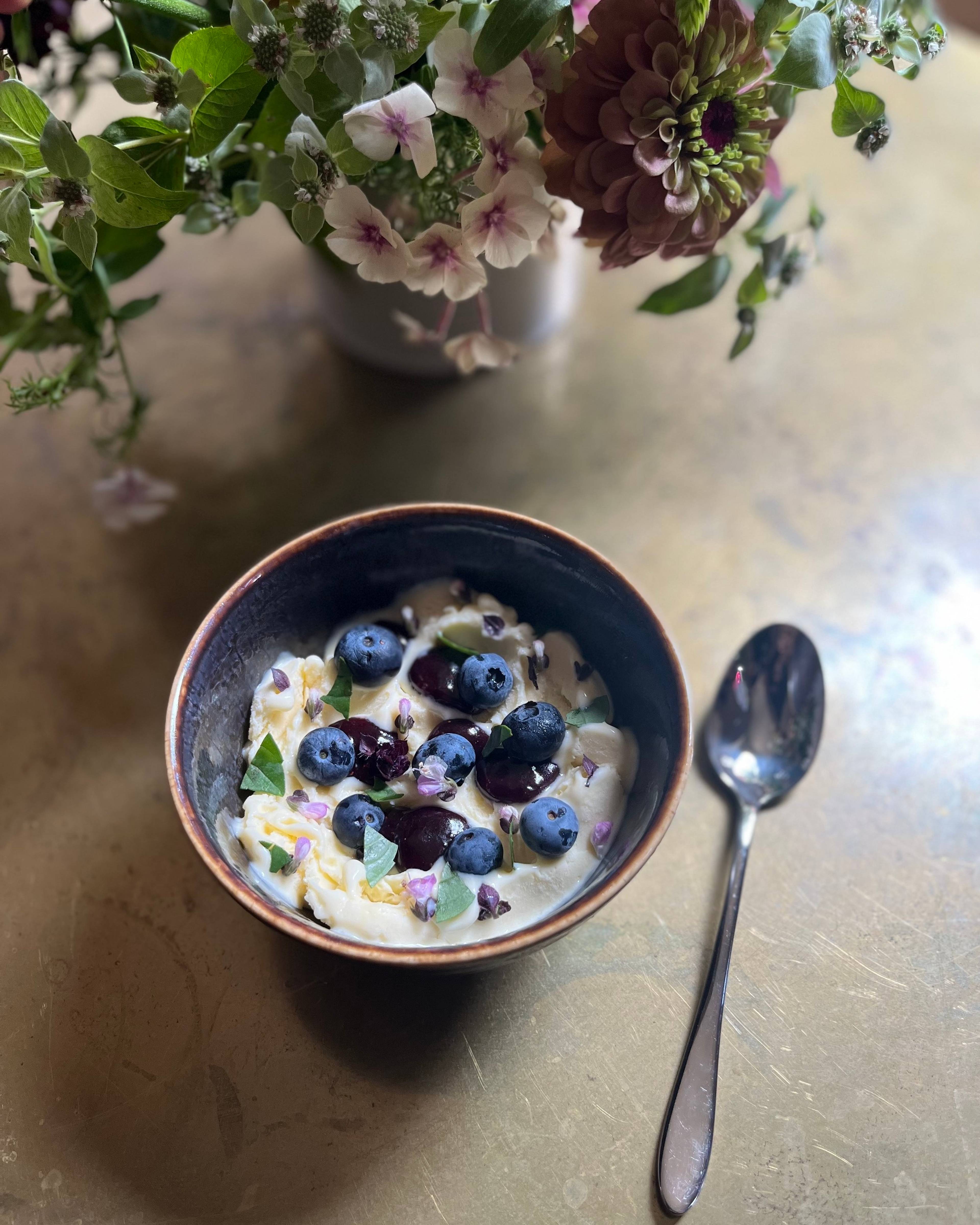 Blueberry jam in a bowl with ice cream and fresh blueberries