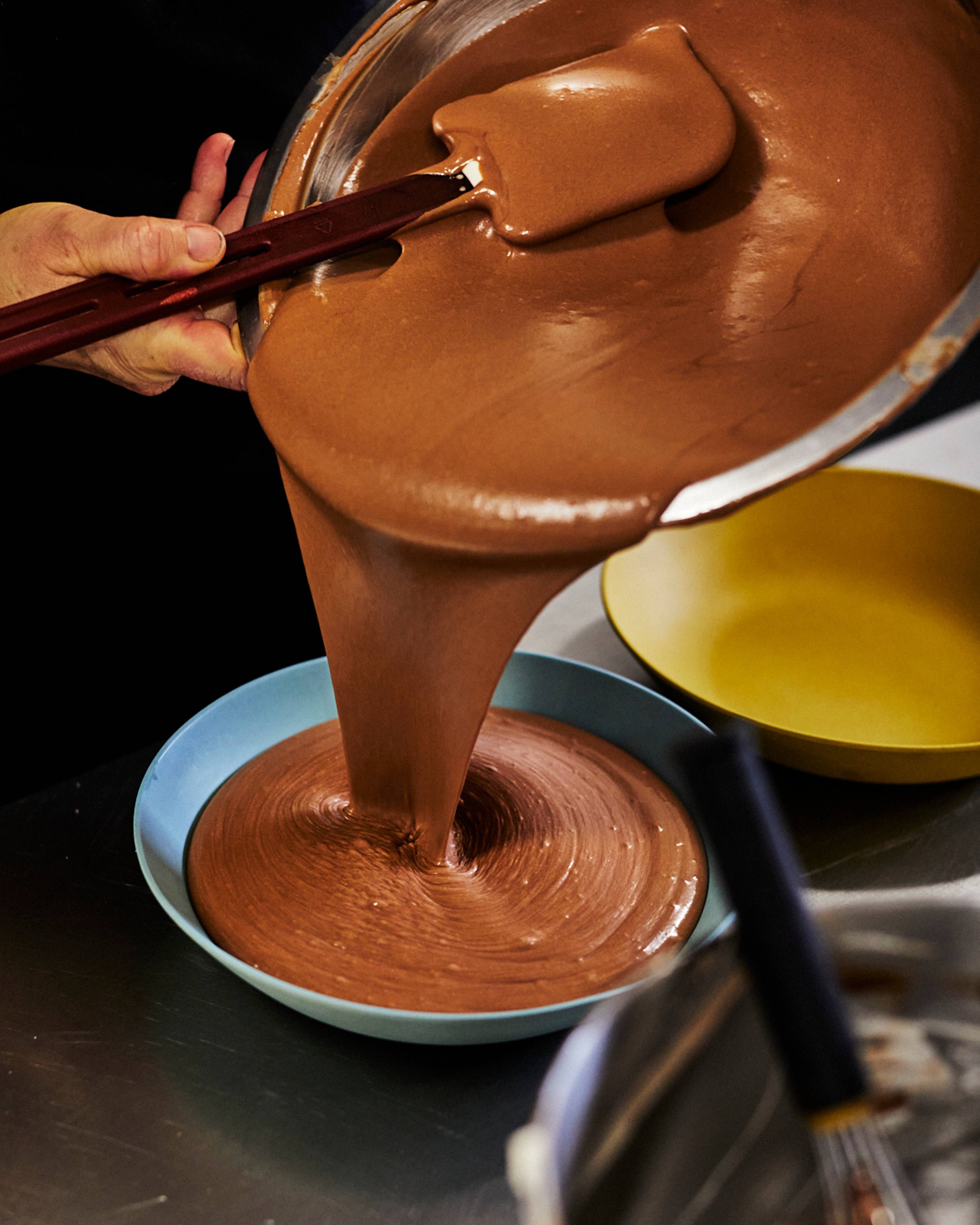 chocolate mousse mix being poured into serving bowl