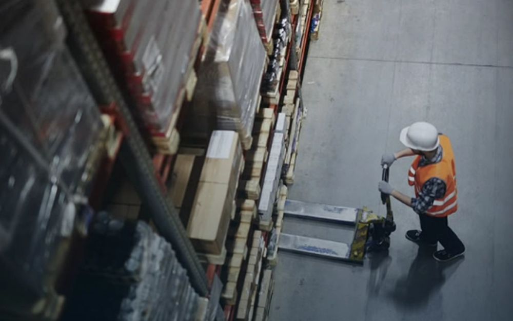 a man is pushing a forklift in a warehouse a man is pushing a forklift in a warehouse