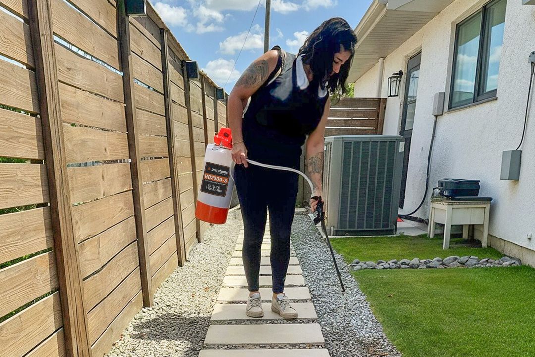 Pea gravel installation in a garden bed border, with PetraMax Rock Glue Max applied to prevent scatter