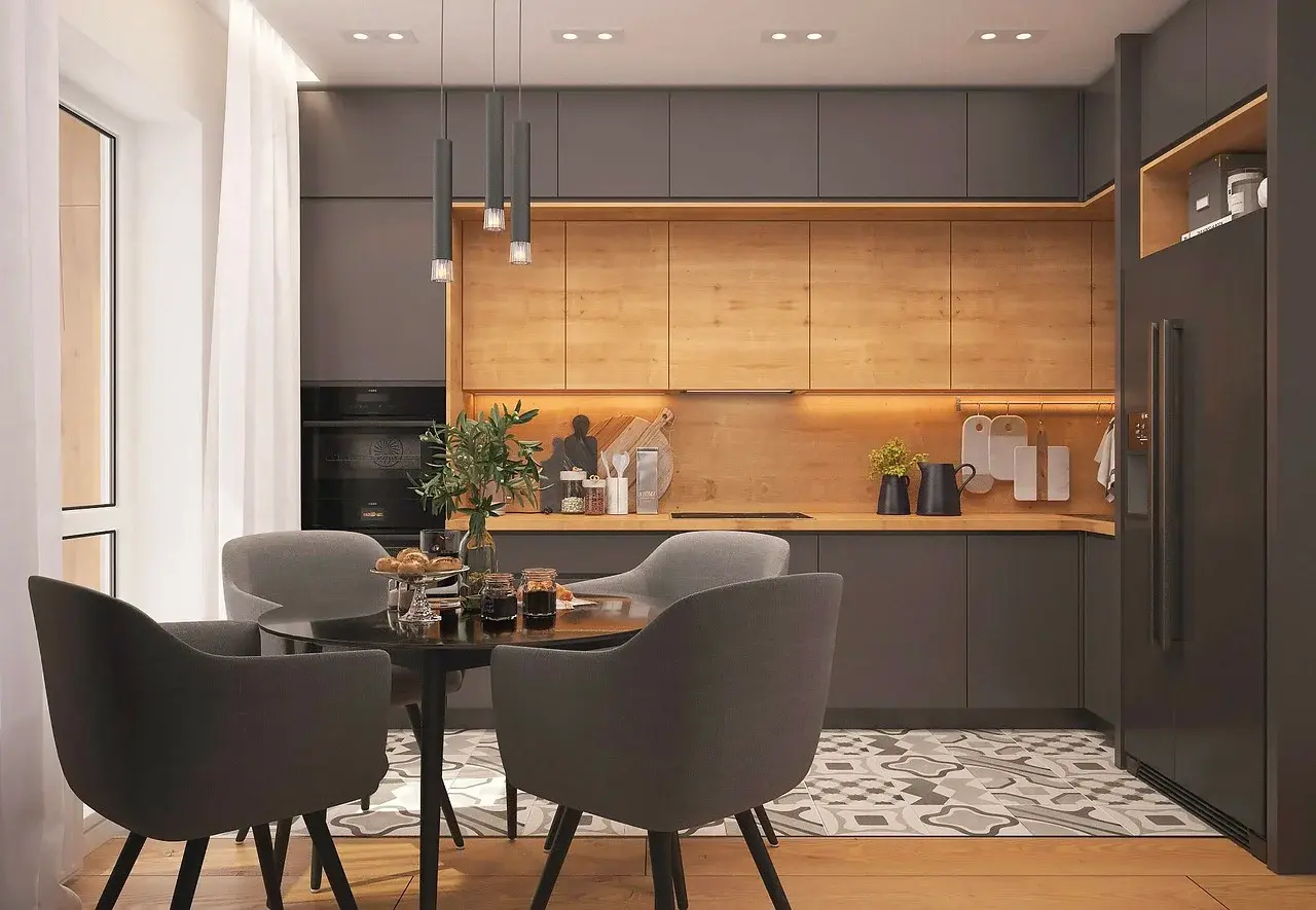 Grey and wood kitchen with a round dining table and grey upholstered chairs