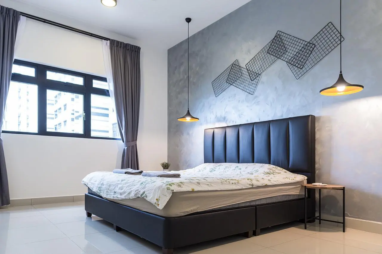 Bedroom with a grey textured accent wall, wire wall art and pendant lamps
