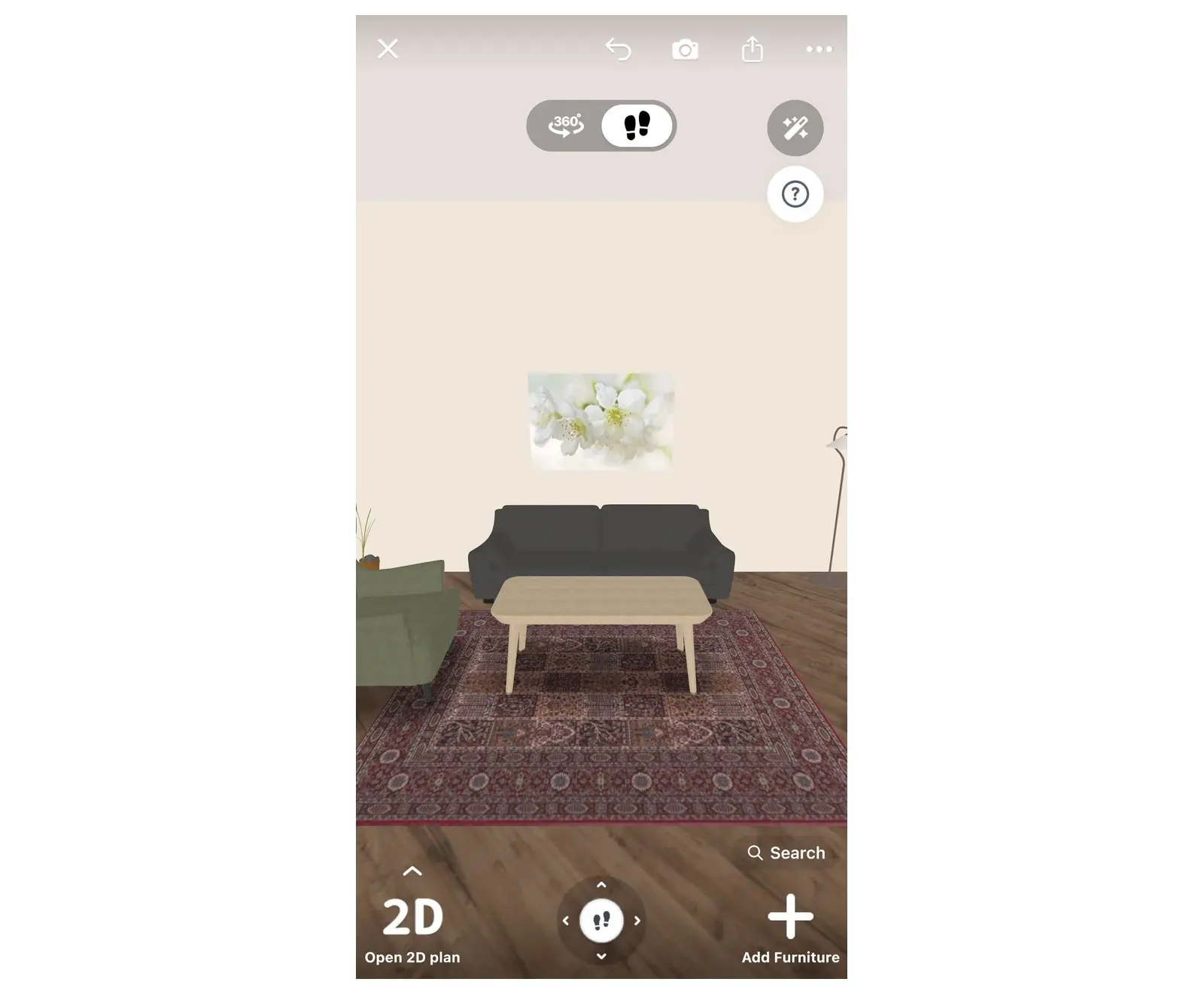 A living room in Home Planner in 3D with the grey sofa from the product card against the wall, a coffee table, an armchair and a rug