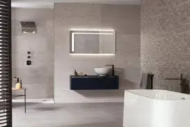 Minimalist bathroom with grey stone-look tiles, a backlit mirror and a freestanding bath