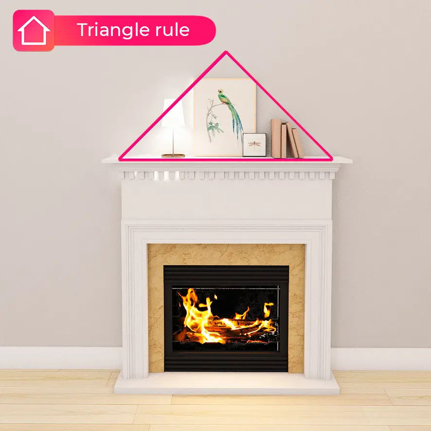 White fireplace mantel decor arranged in a triangle with a framed bird print