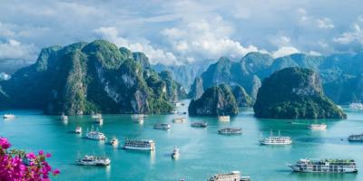 Scenic view of boats on water with mountains in background.