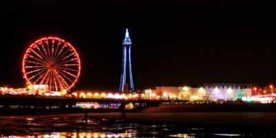 A stunning night view of a Ferris wheel and amusement park in Blackpool.