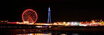 A stunning night view of a Ferris wheel and amusement park in Blackpool.