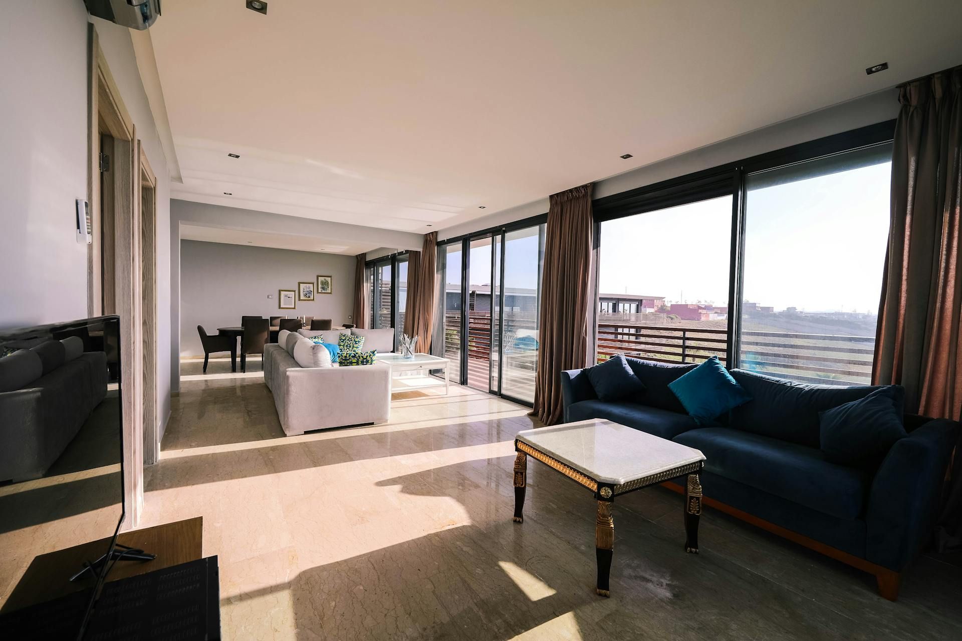 A photo of a living room with large open windows