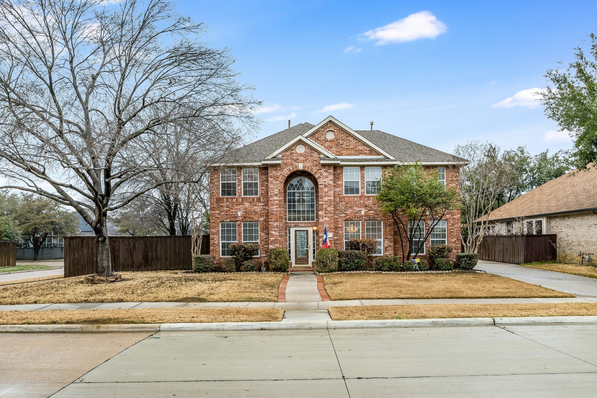 A large two-story brick home in Grand Prairie, Texas