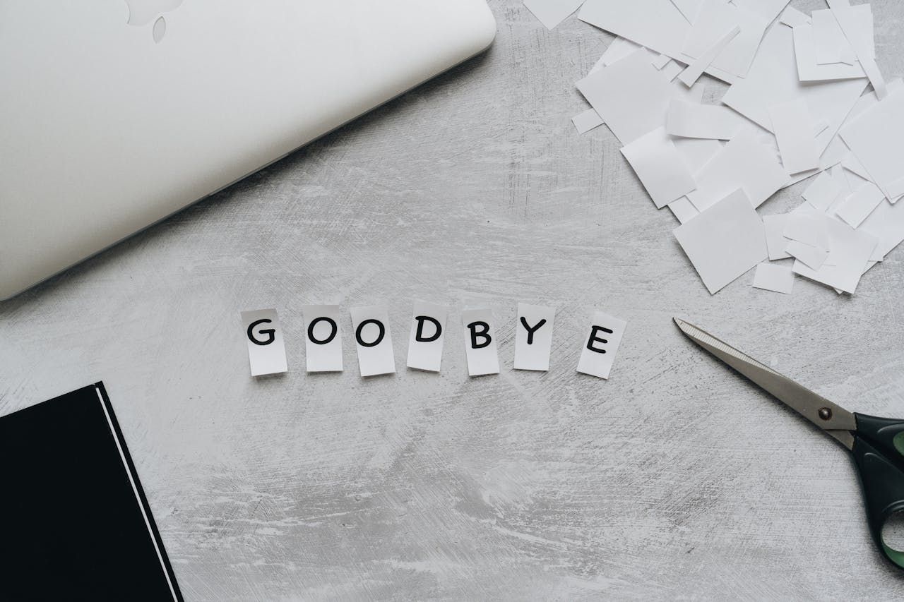 a series of cut-out letters spelling "Goodbye"