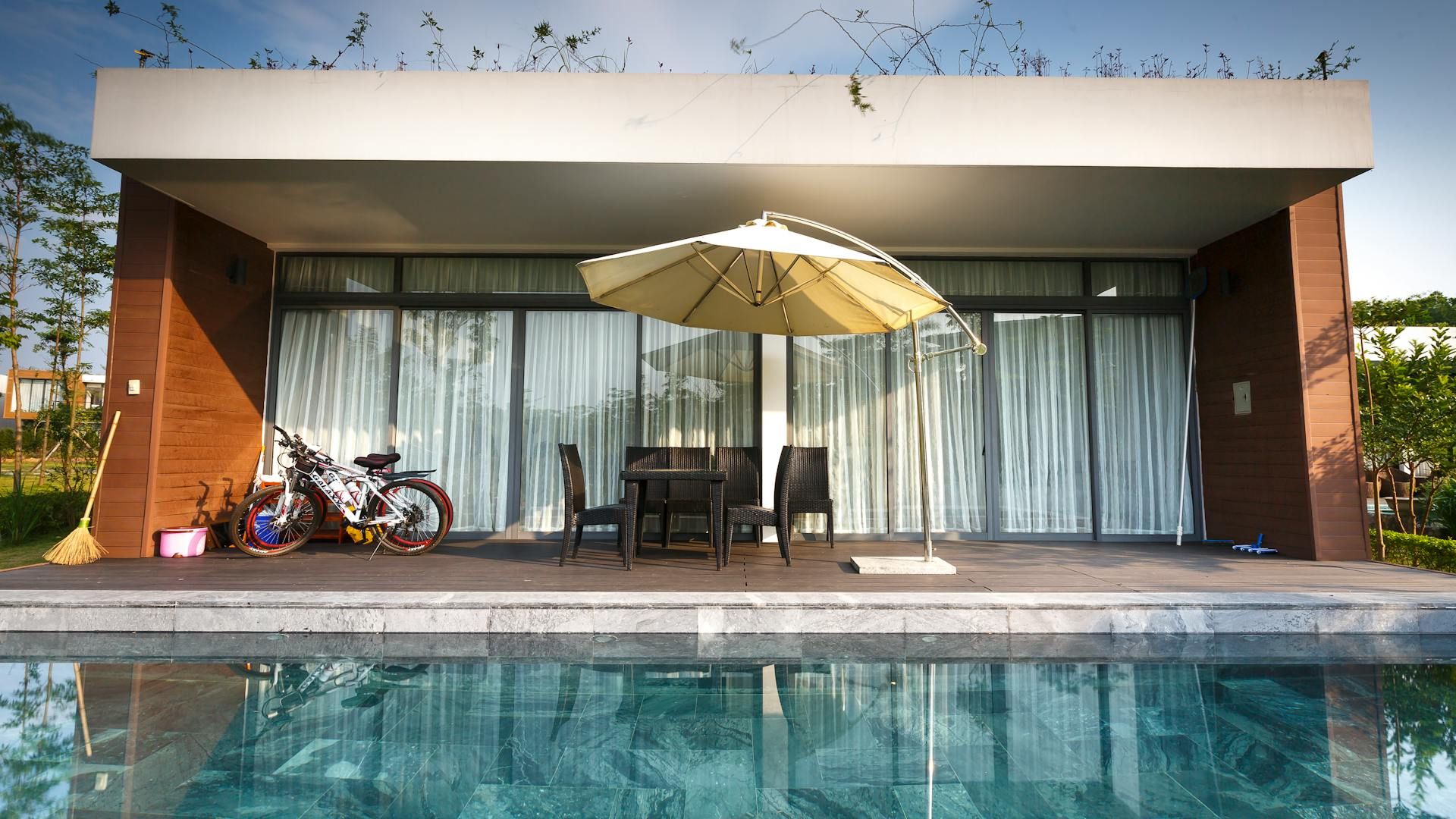 Bikes Near Chairs and Cantilever Parasol