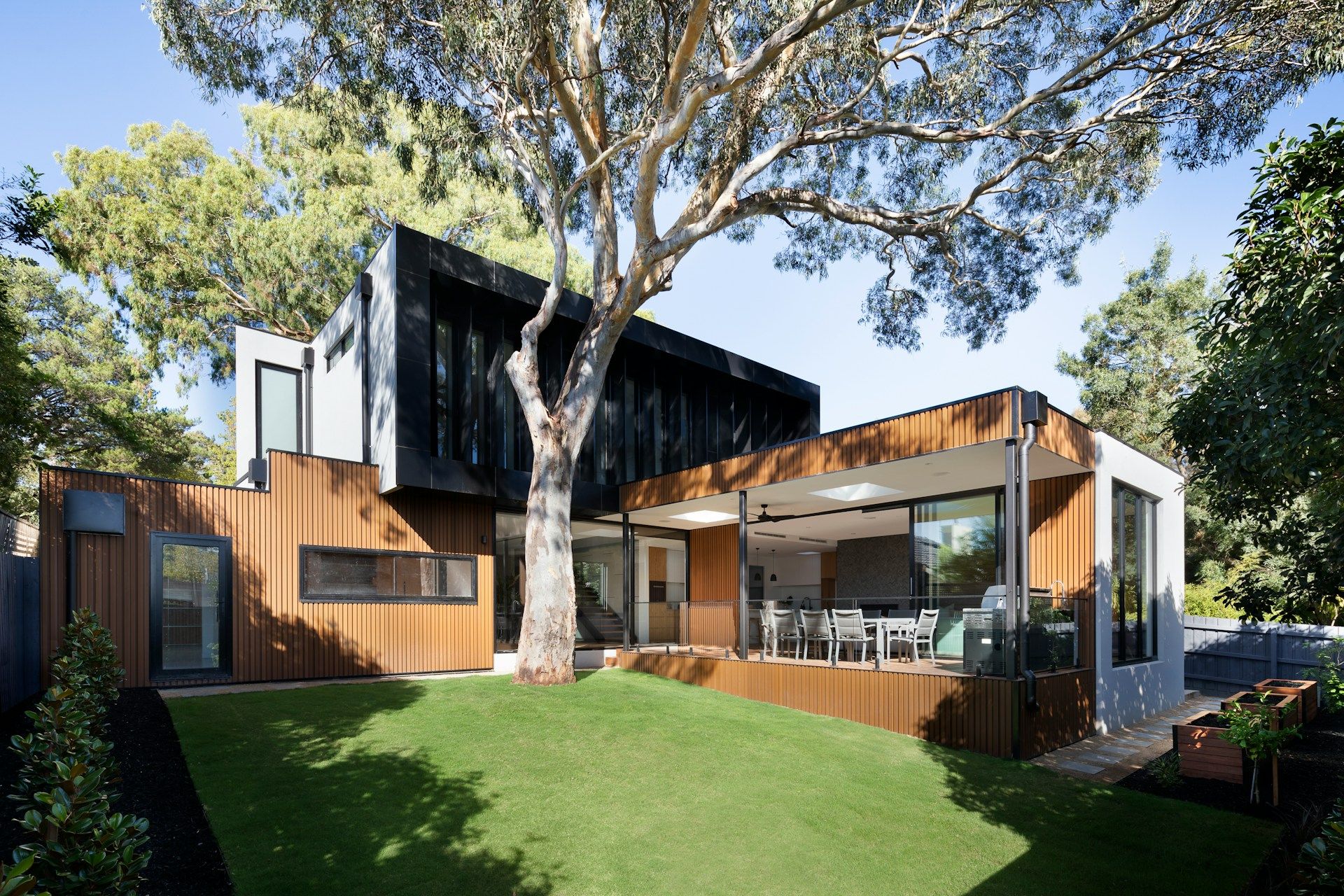 modern wooden house near green tree