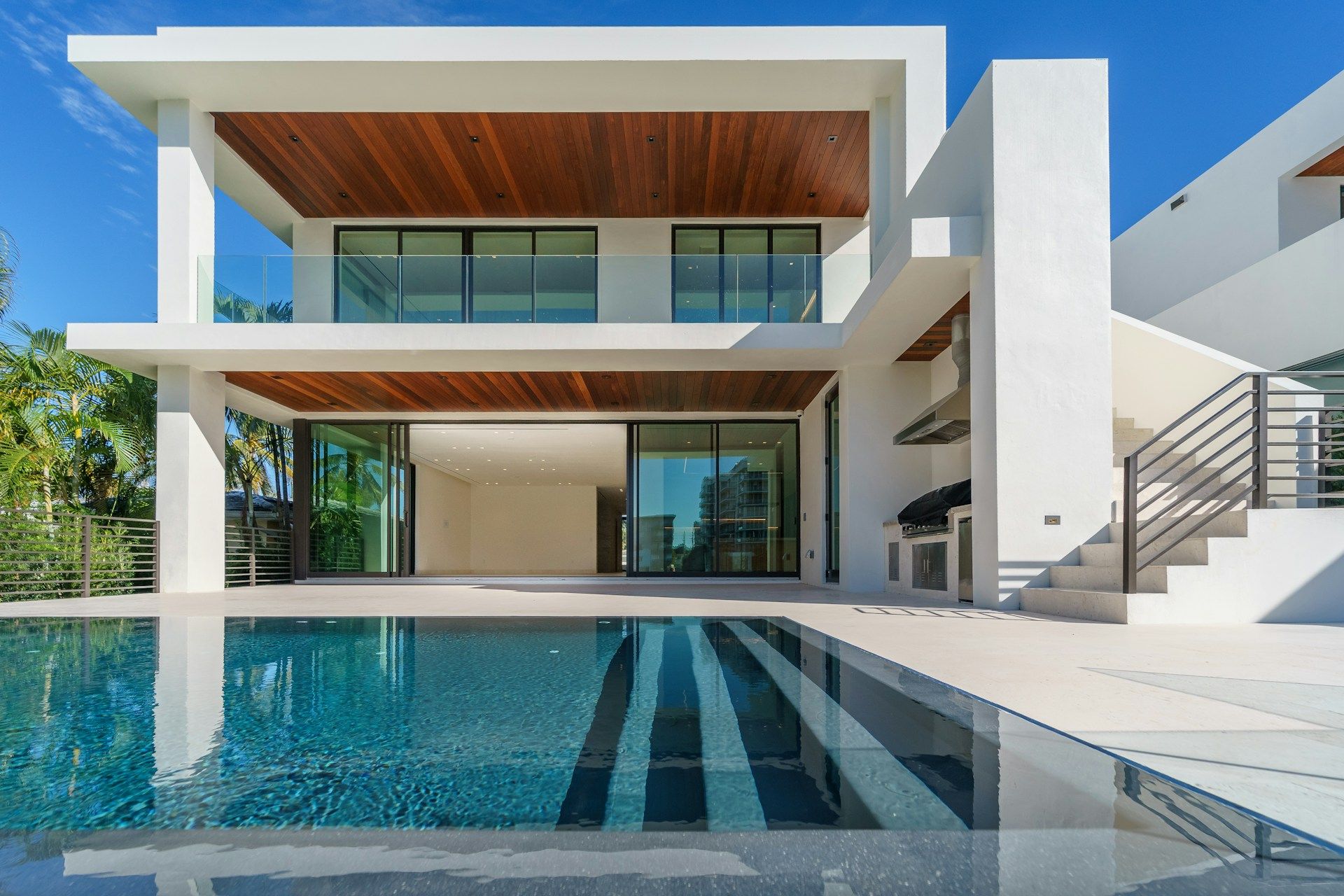 White and brown house with swimming pool