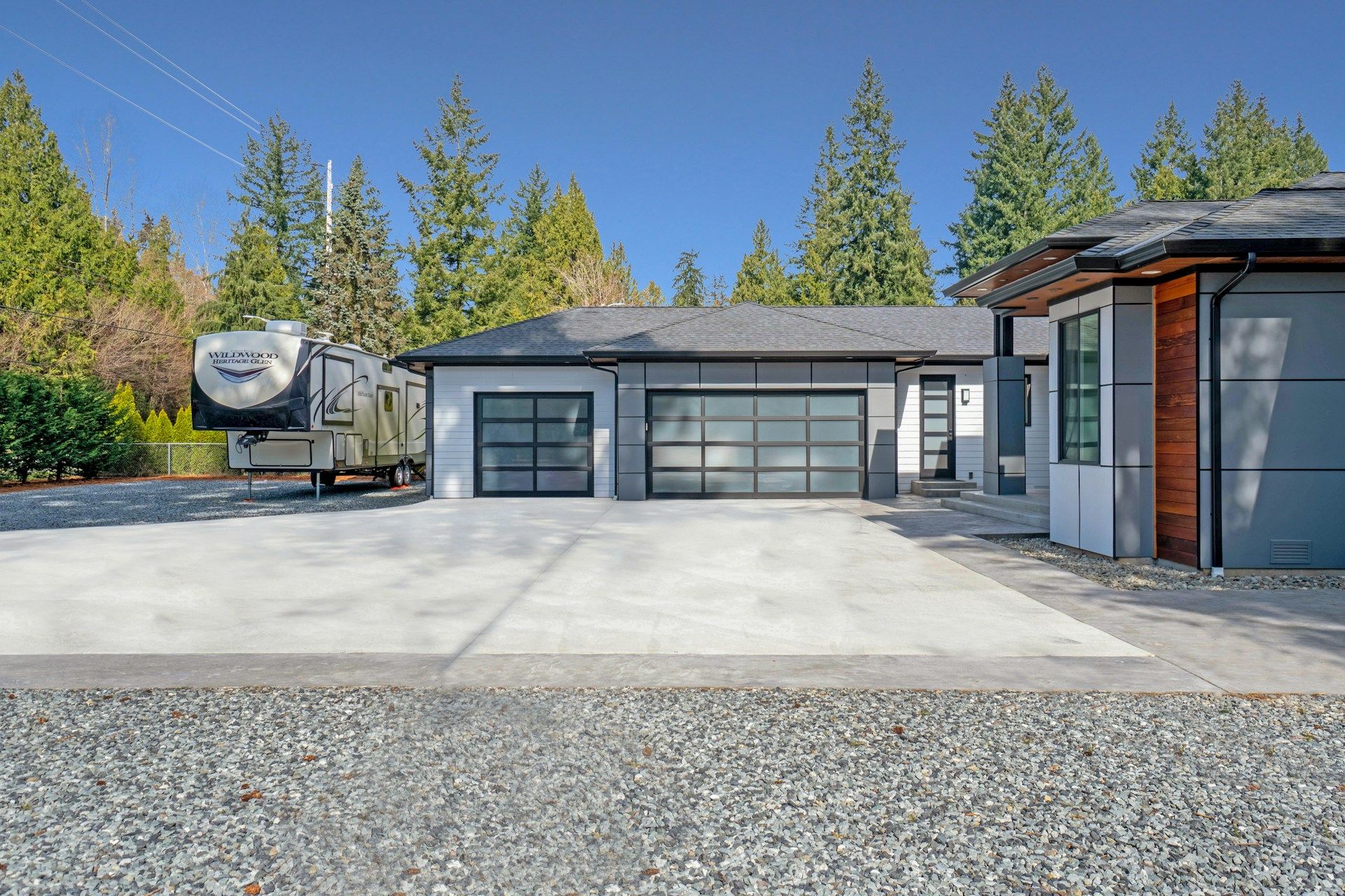 white and gray wooden house near green trees during daytime