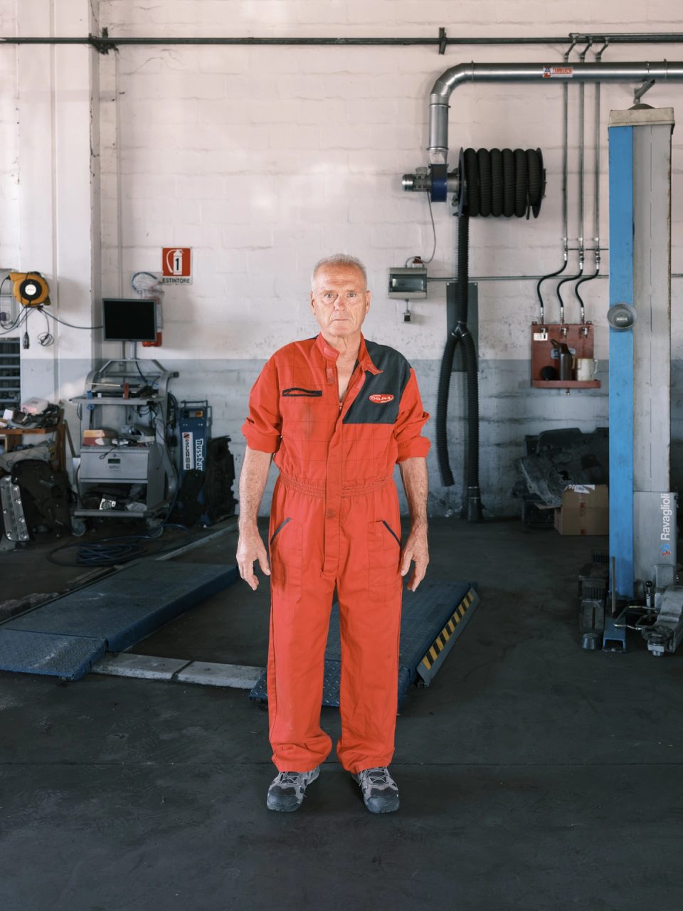 Mechanic wearing orange coveralls in a workshop