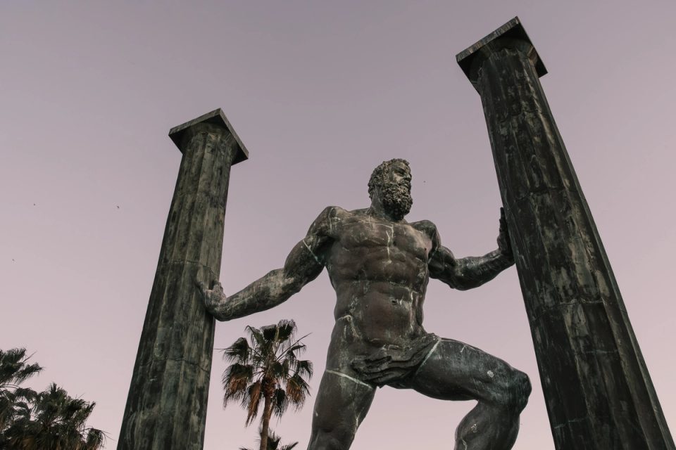 Monumental statue of a man standing between two pillars