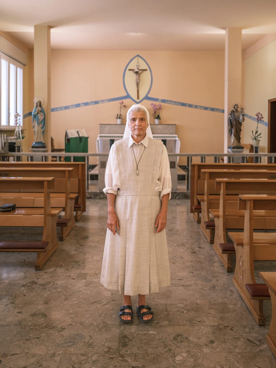 Nun standing inside a church