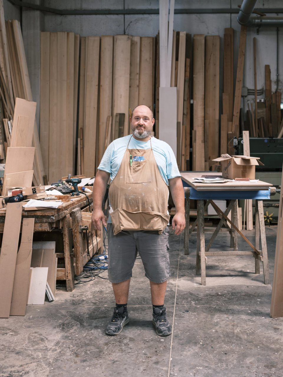 Carpenter standing in a woodworking workshop