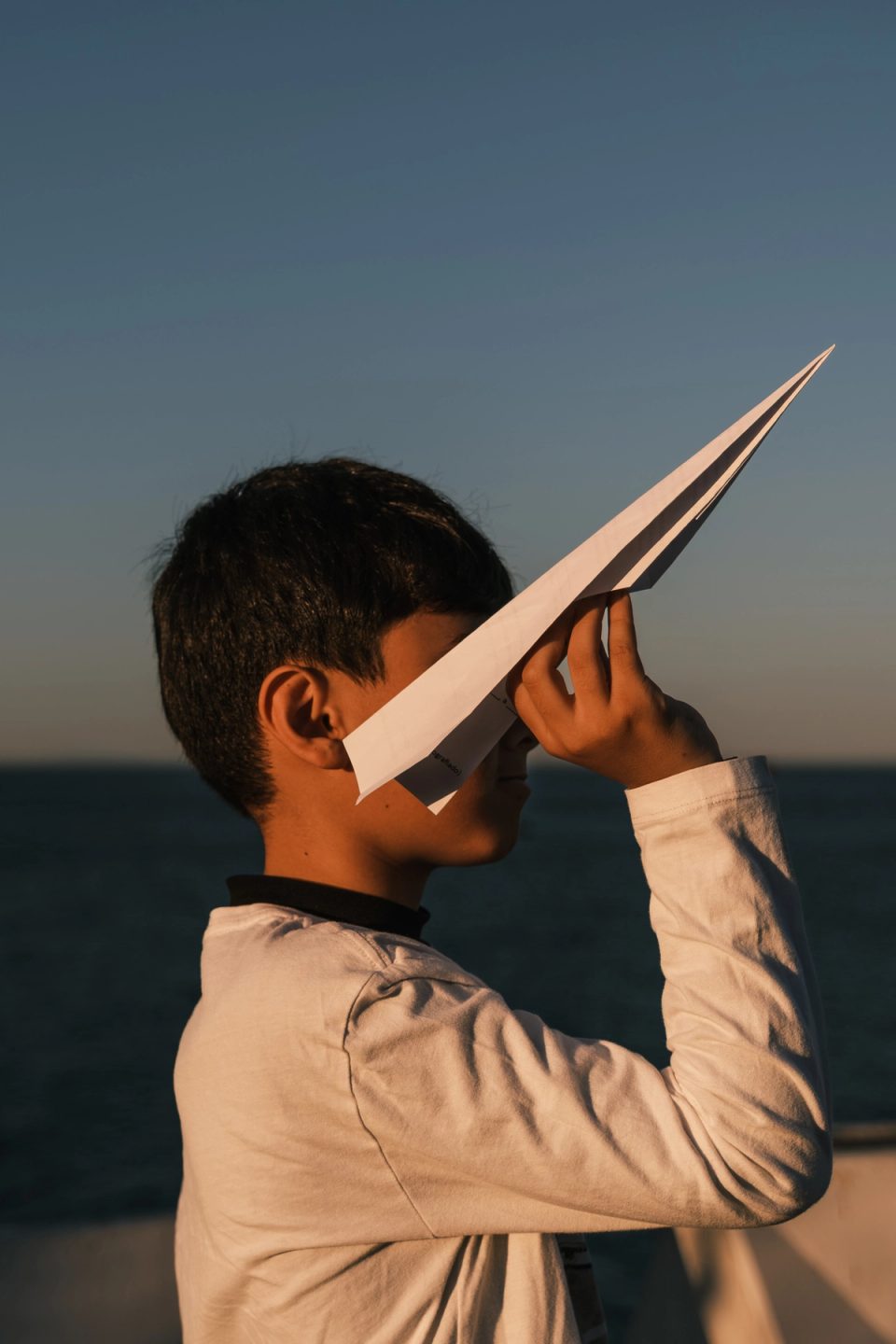Child holding a paper airplane