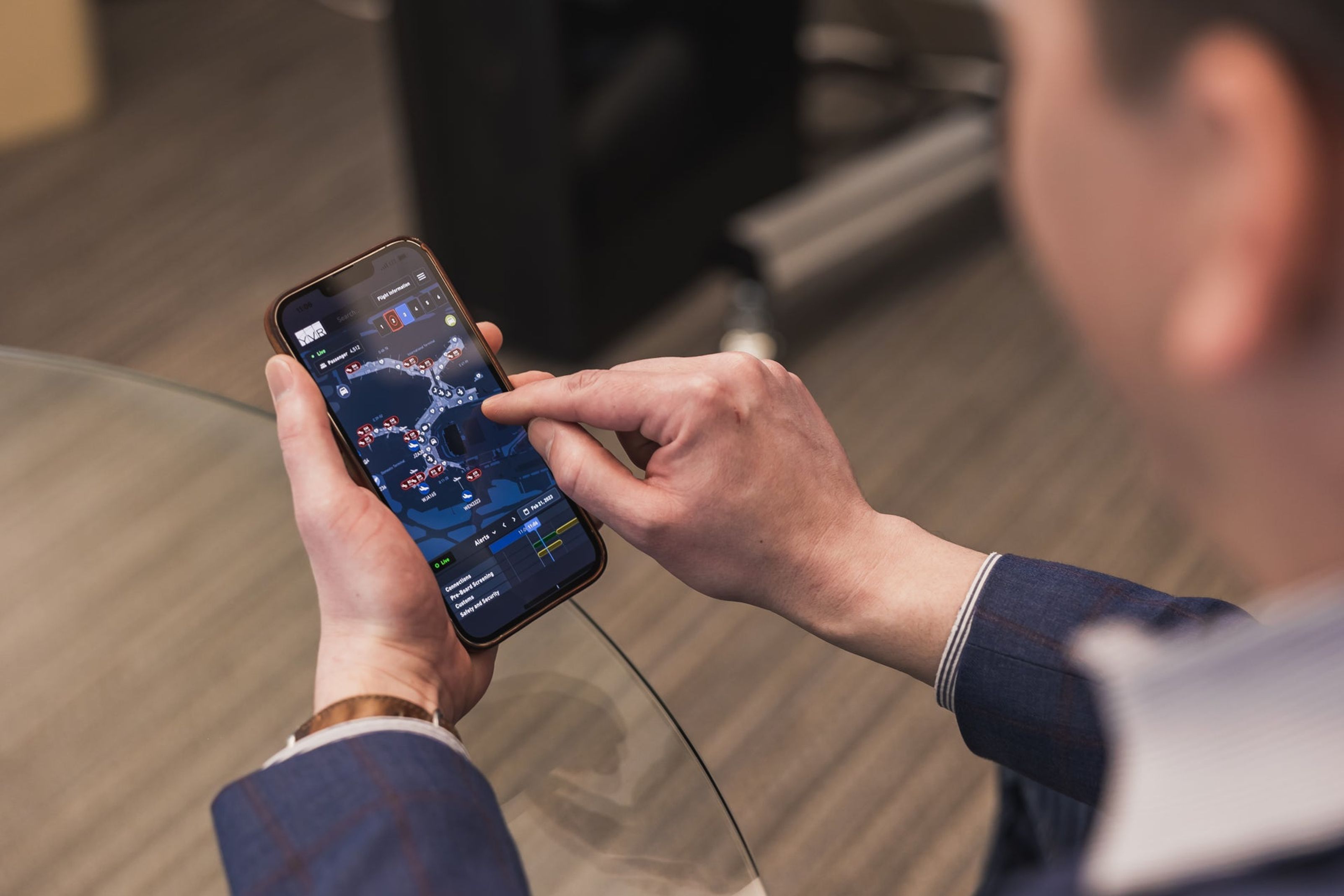 A man visualizing the airport data on a mobile phone