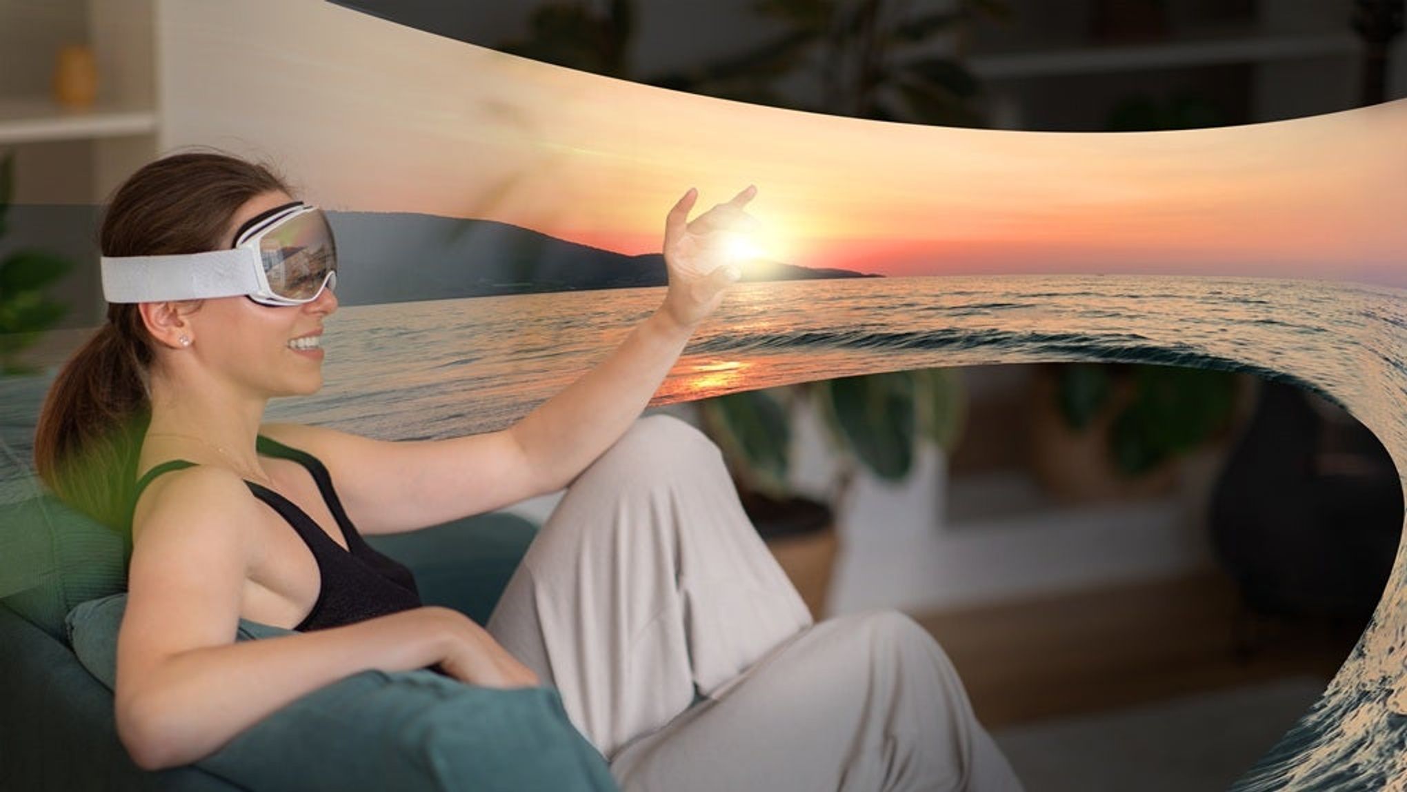 A woman is sitting on a couch wearing a virtual reality headset