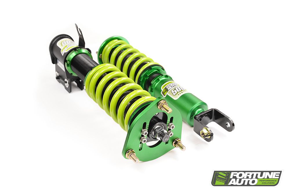 Pair of green adjustable coilover suspension units