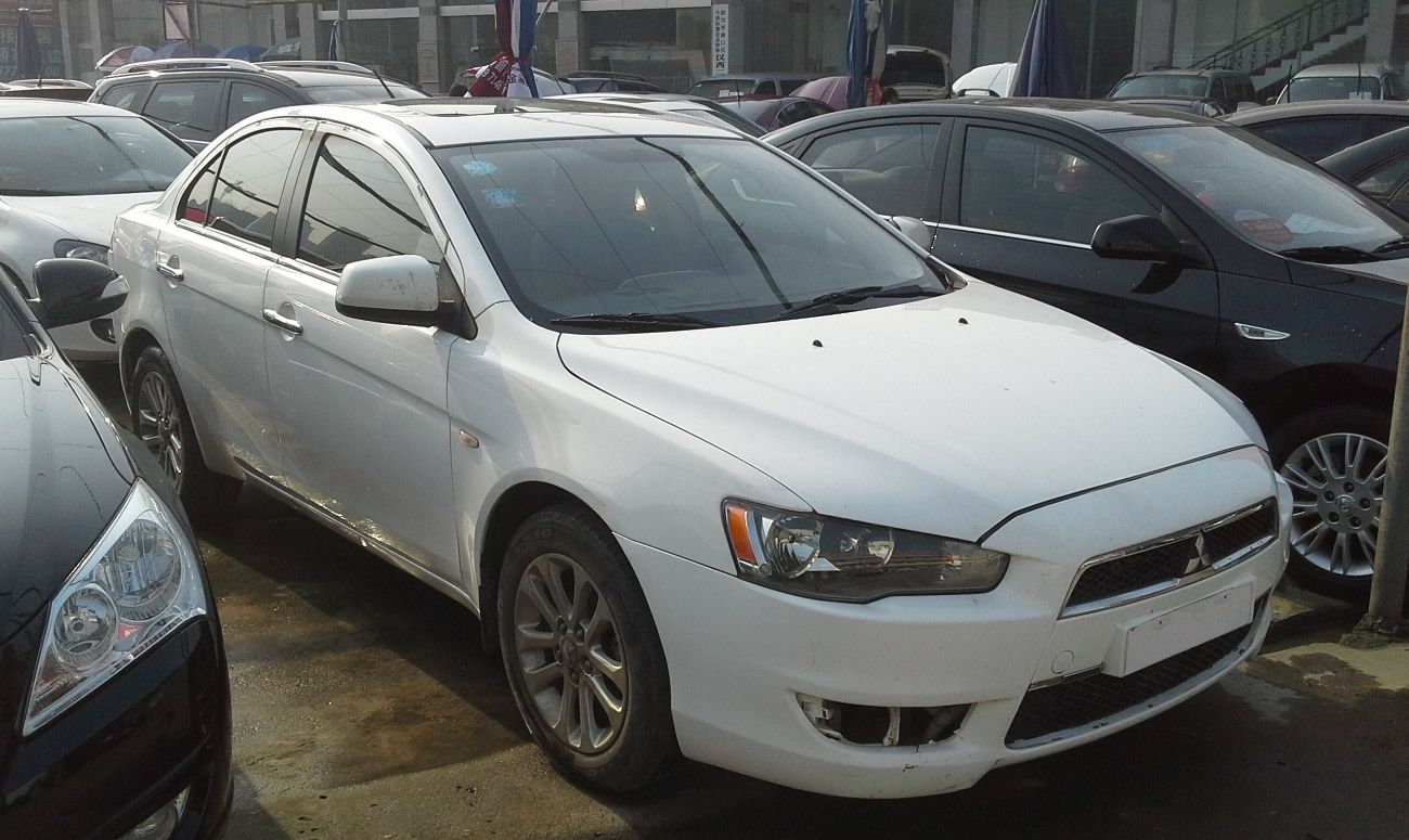 White Mitsubishi Lancer EX photographed in Wuhan, China; illustrative non-US car