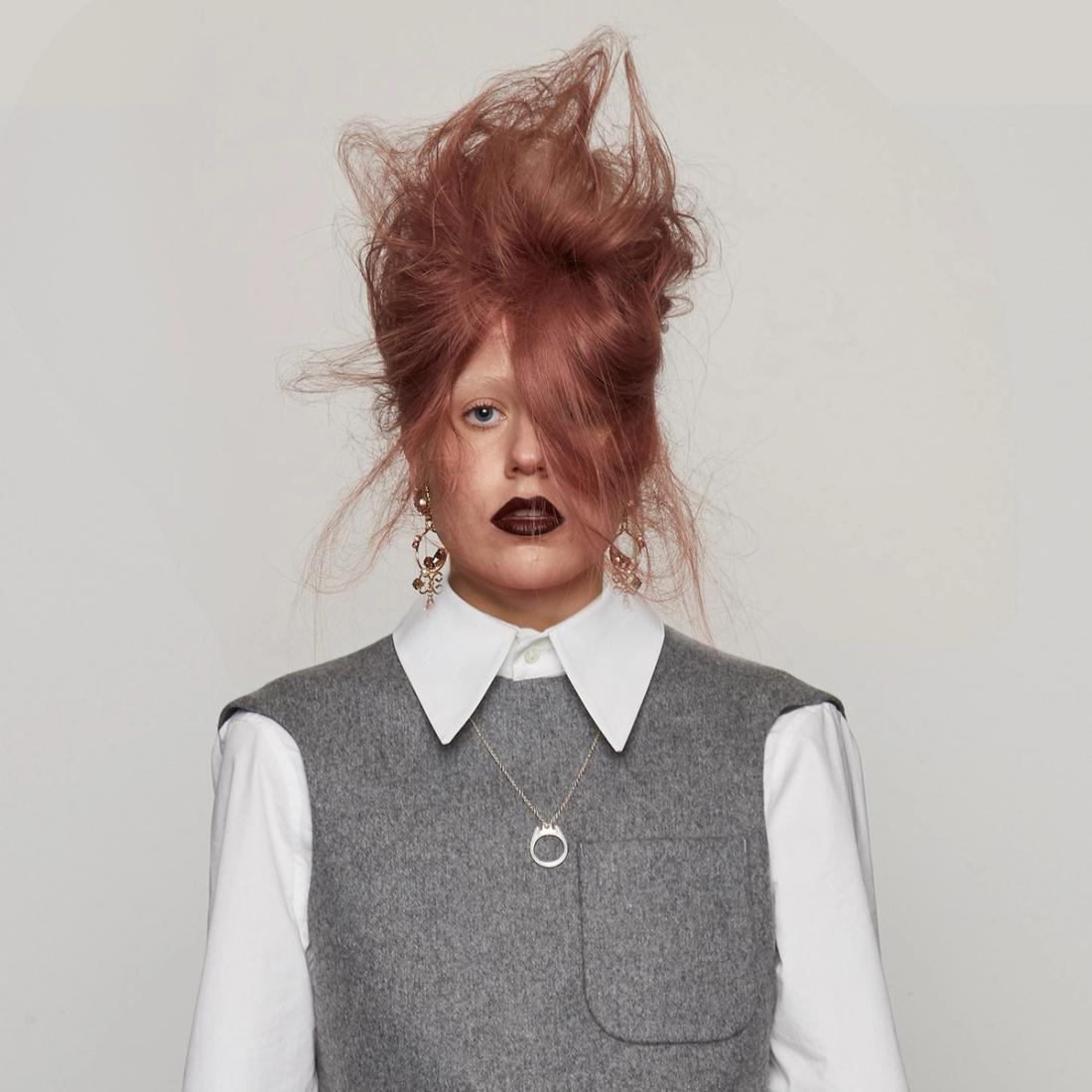 Model with voluminous, rose-pink coloured hair
