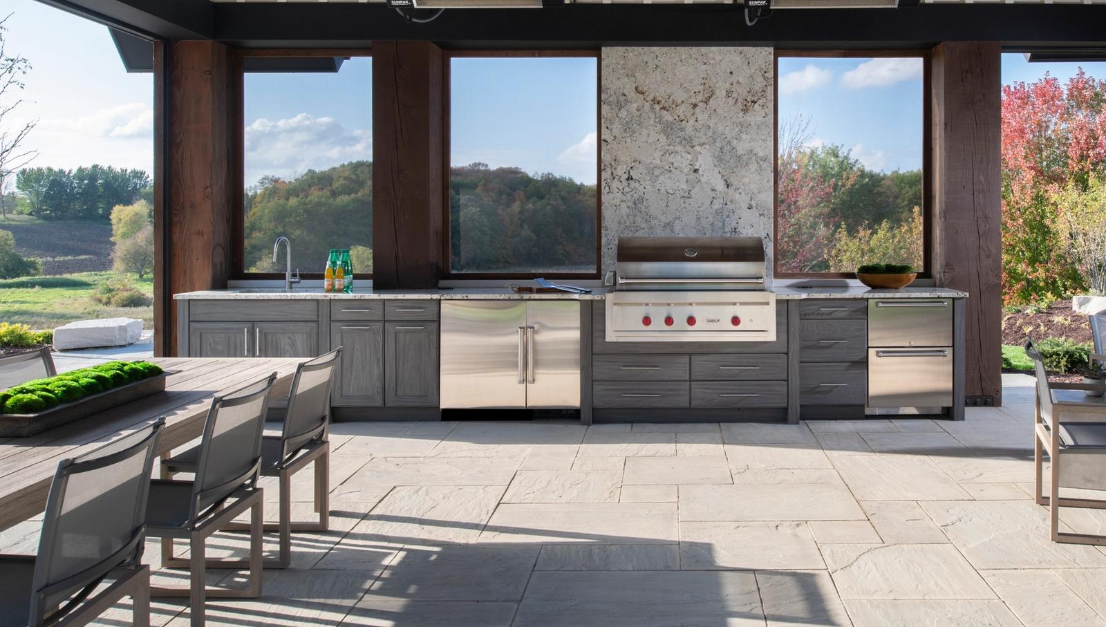 Pavilion outdoor kitchen in weathered grey cabinetry with a built-in grill