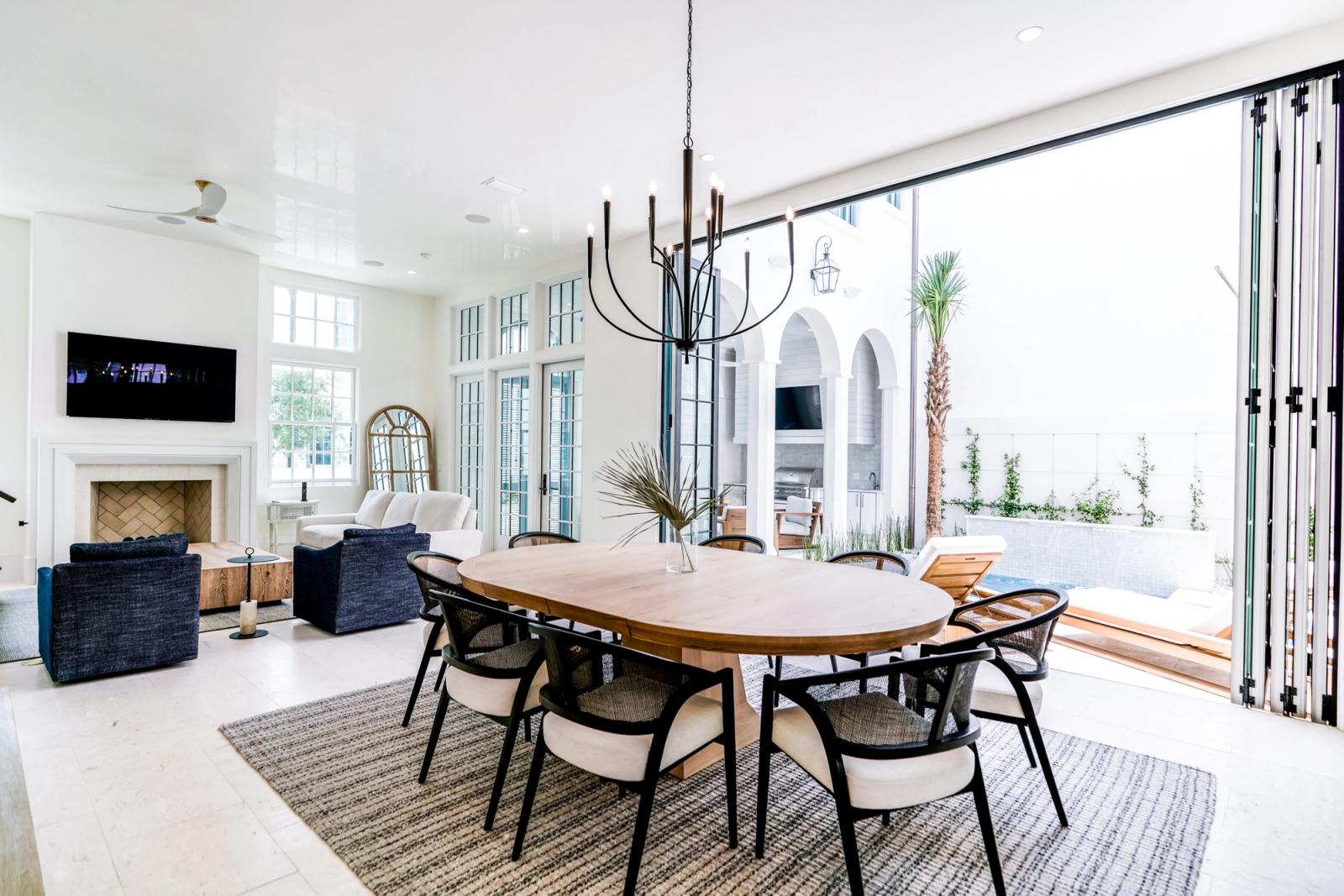 bright alys beach dining room with outdoor courtyard kitchen
