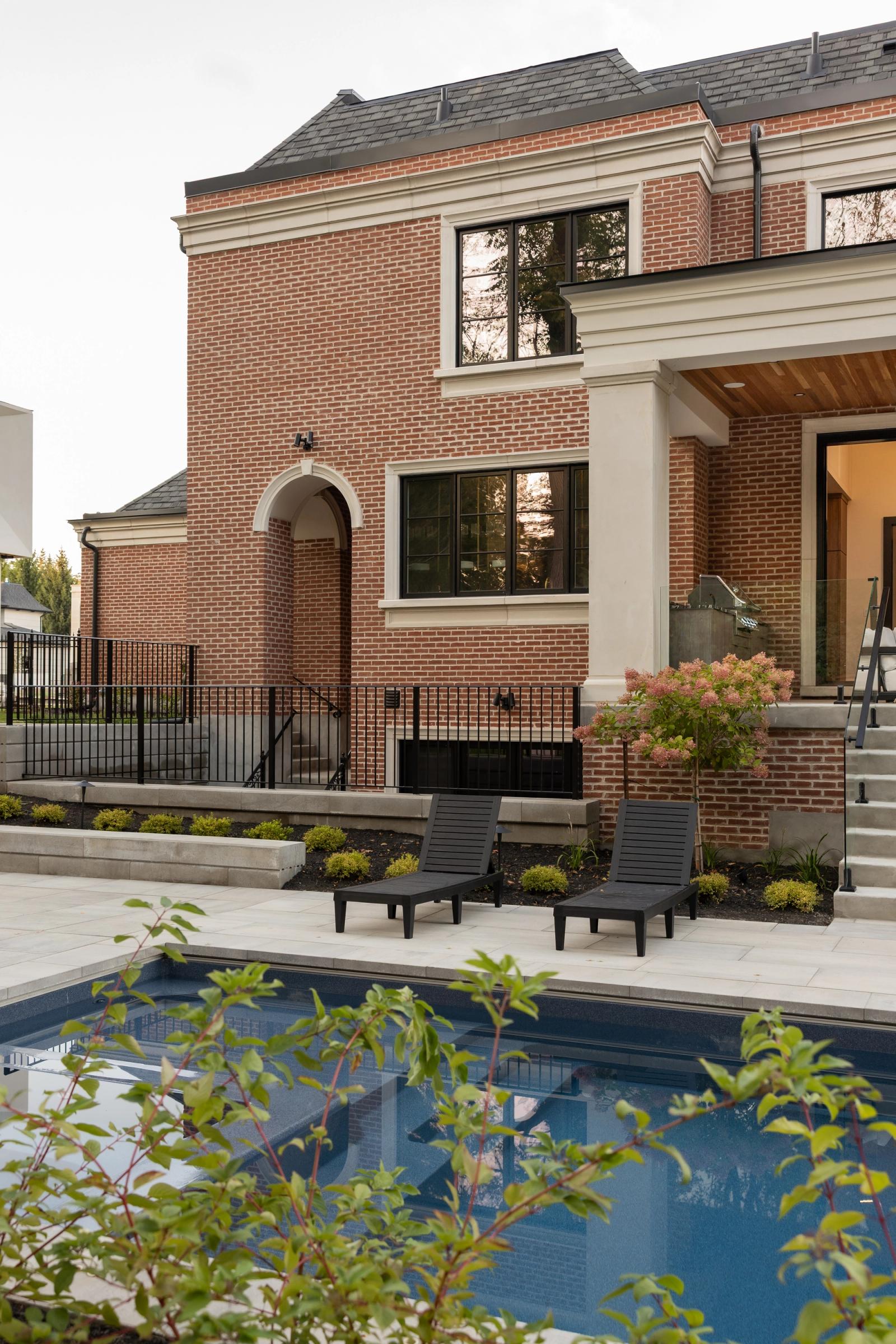 Brick home with a built in outdoor kitchen in the terrace wall