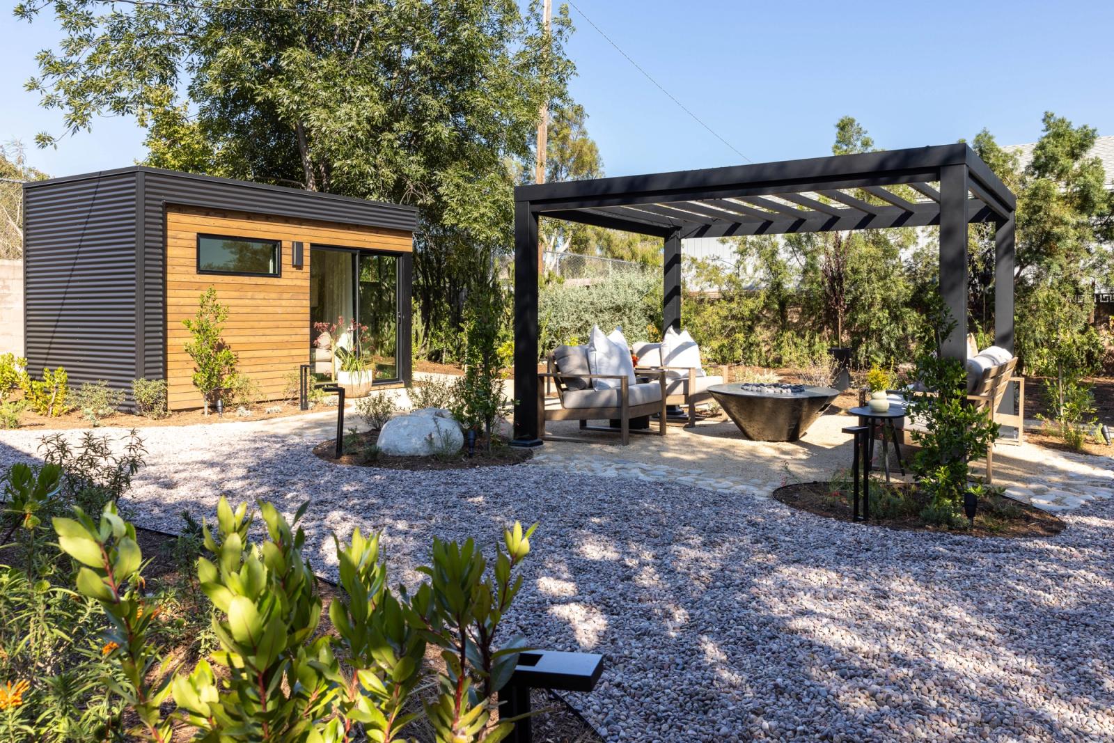 Modern garden retreat with a black pergola and outdoor kitchen in california