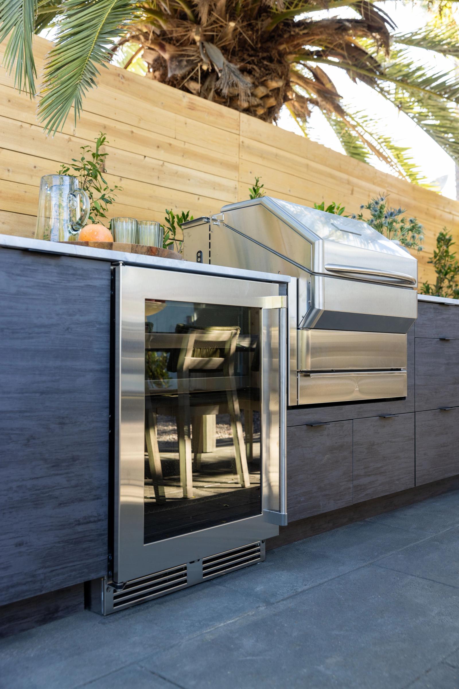 modern outdoor kitchen with slab door and beverage fridge