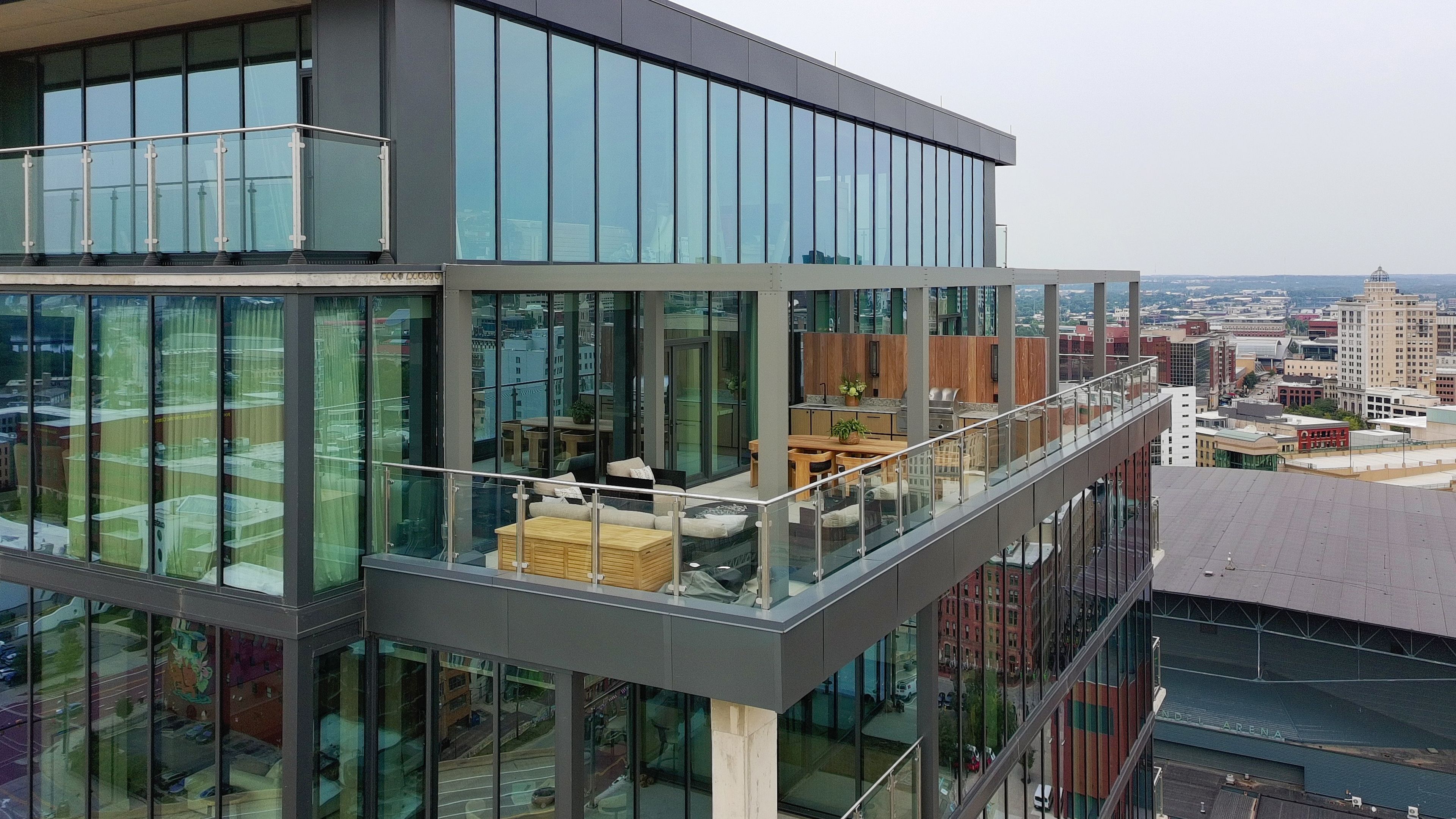 Drone shot of condo balcony with outdoor kitchen and city skyline