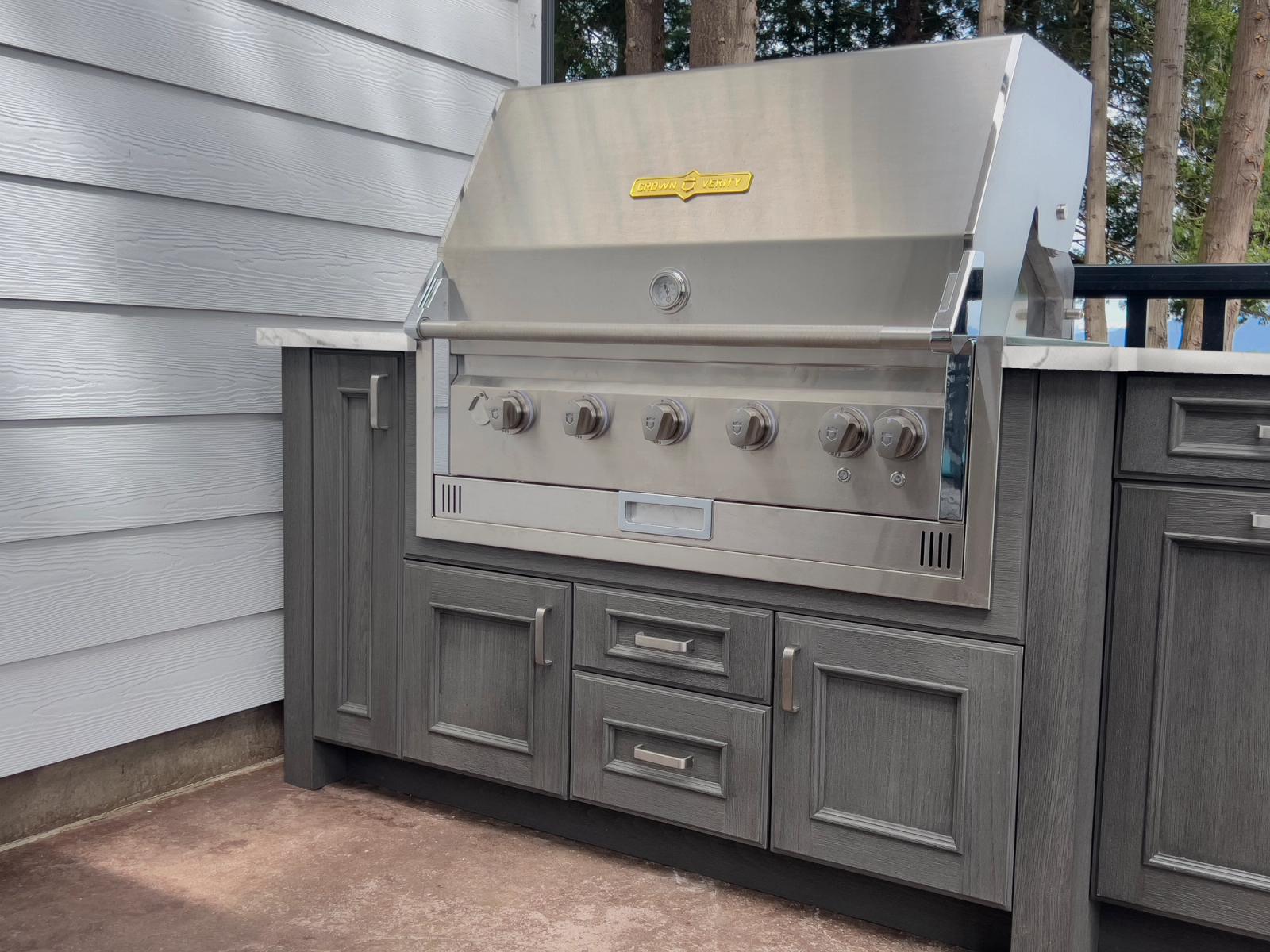 Grey woodgrain outdoor cabinetry built-in stainless grill