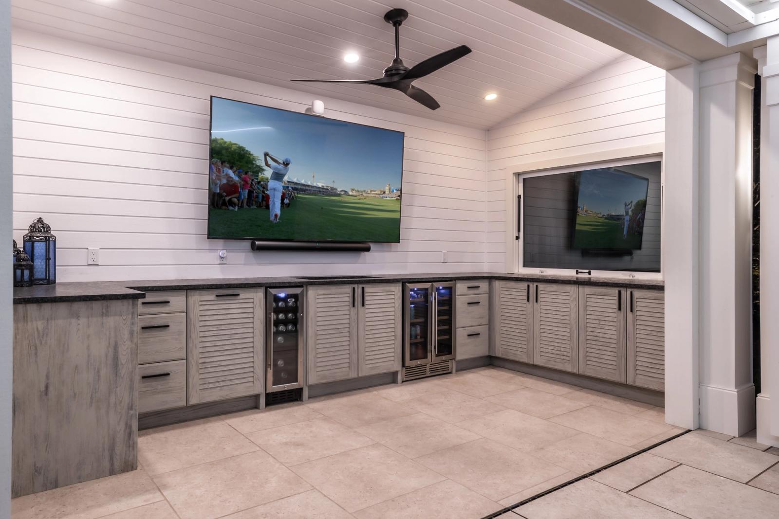 louvered door outdoor cabinets with wine fridge and TV