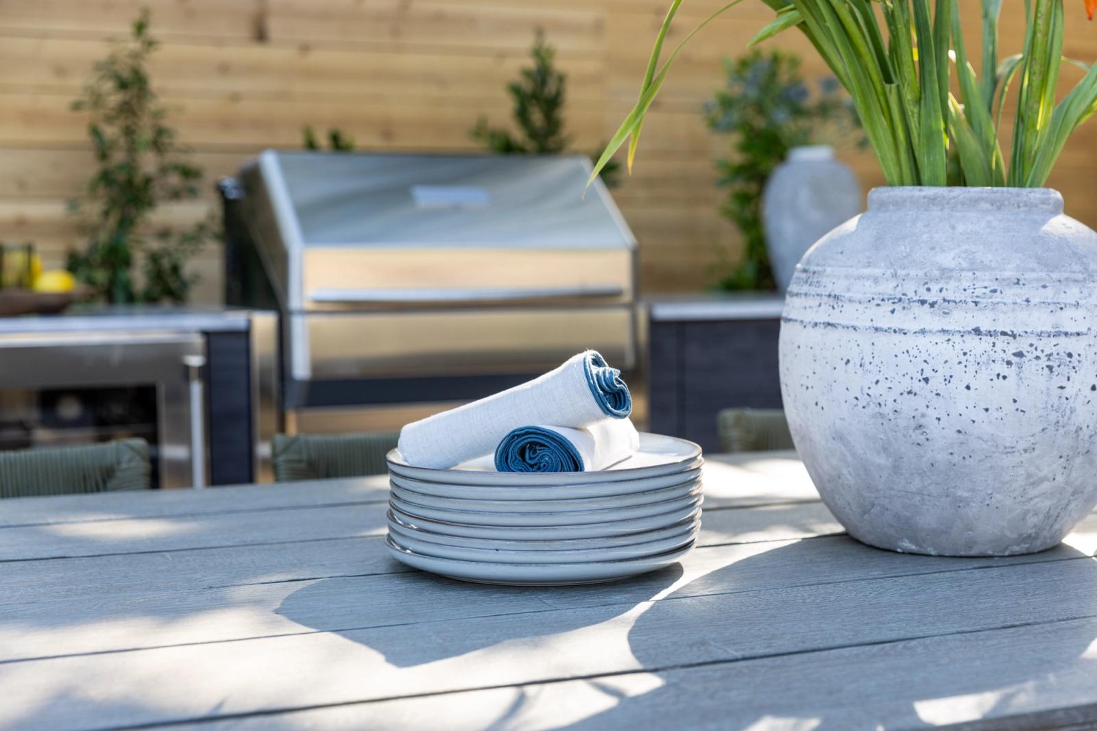outdoor dining table setting with outdoor kitchen