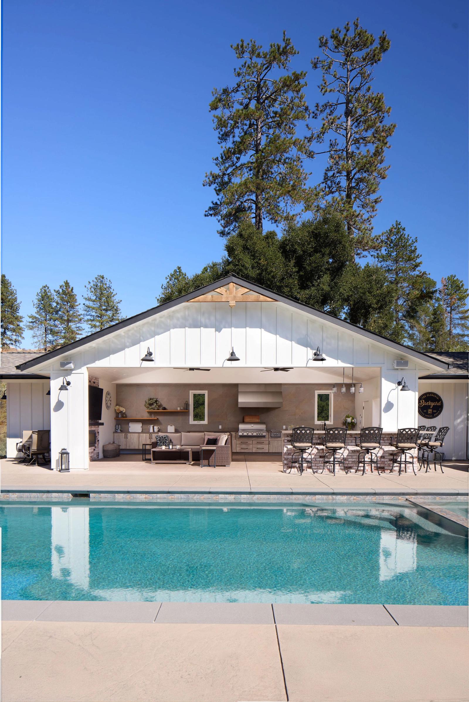 pool pavilion with large outdoor kitchen and built in grill near pool