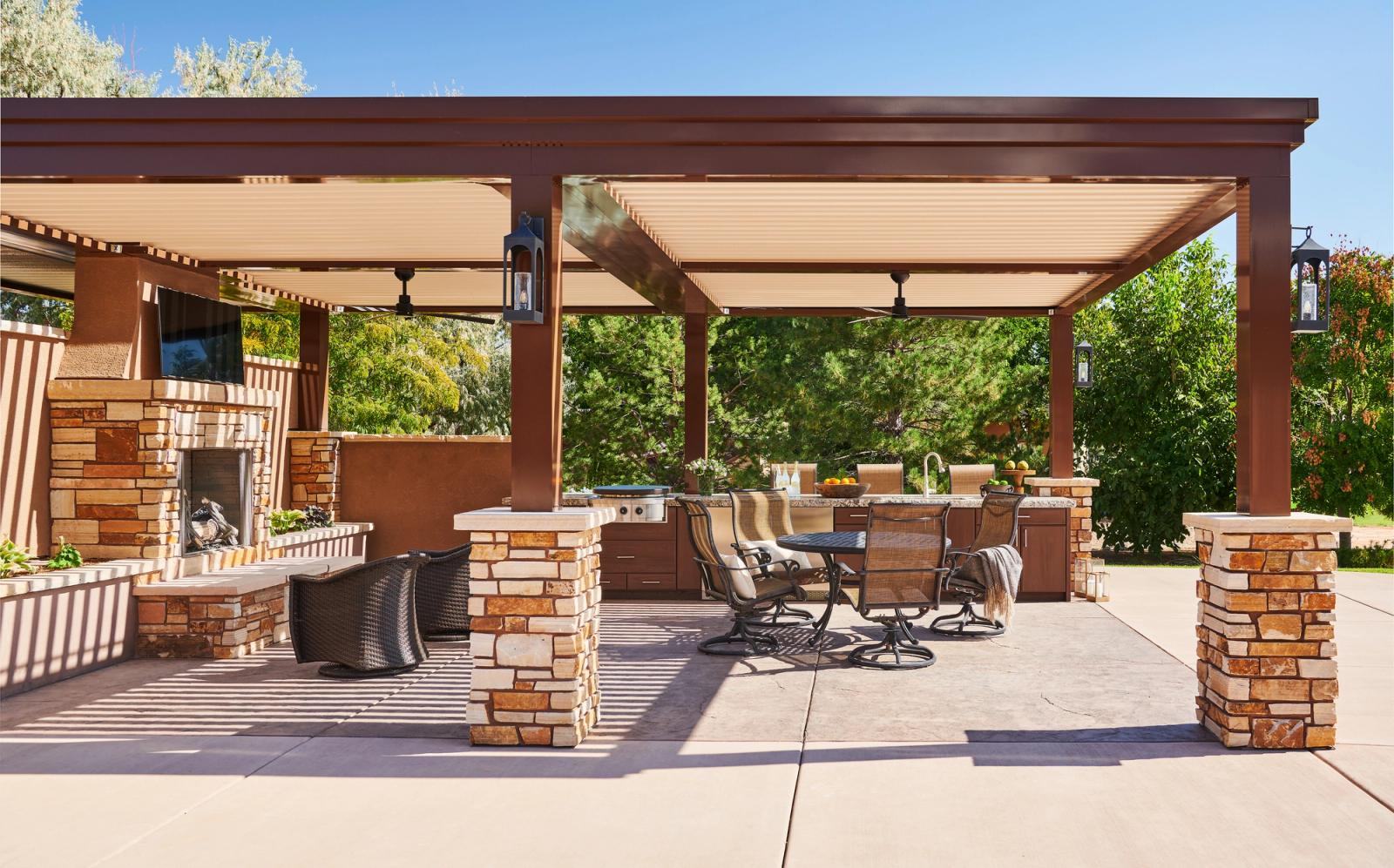 Pergola-covered outdoor kitchen with a island
