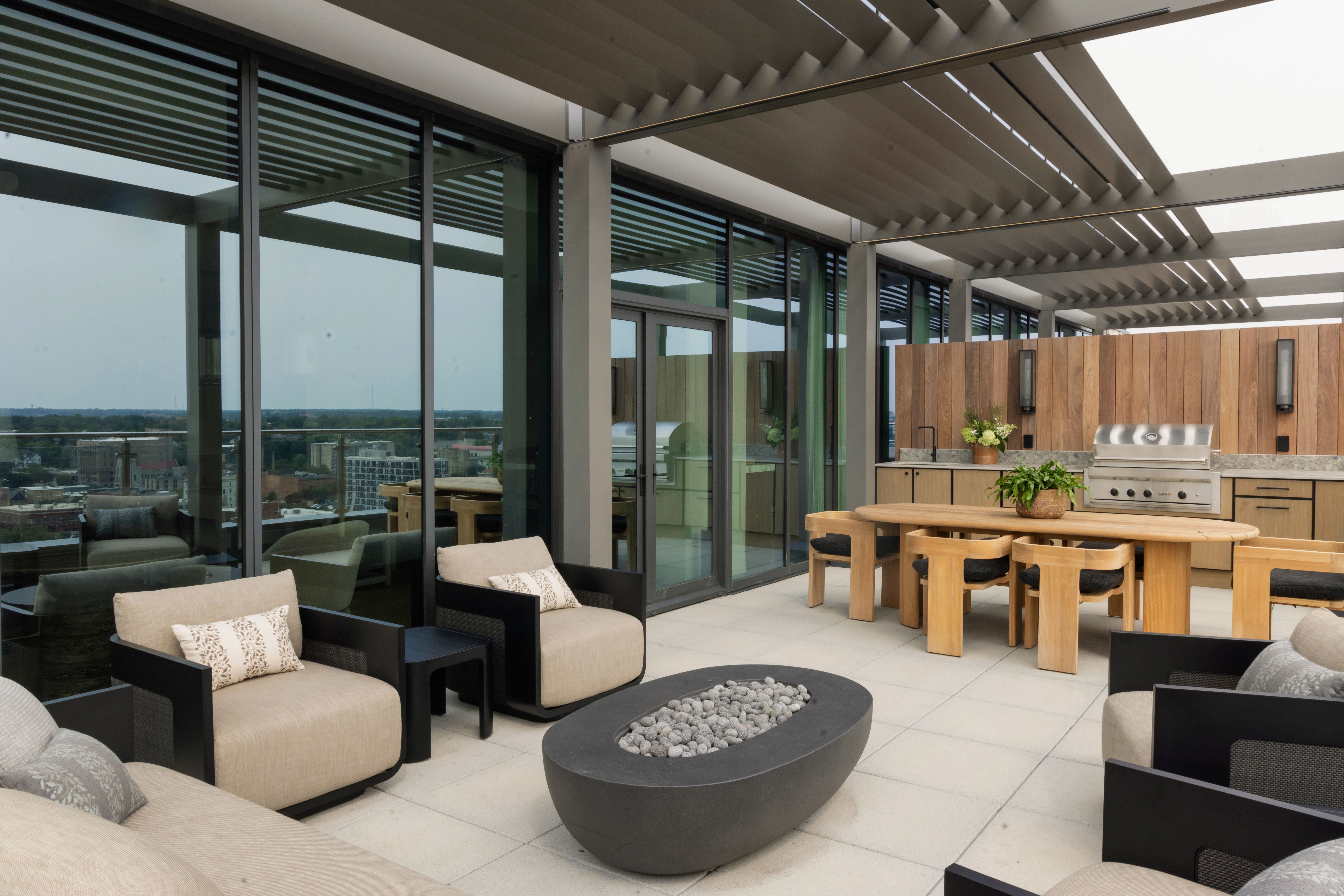 wide shot of condo balcony with outdoor furniture and kitchen