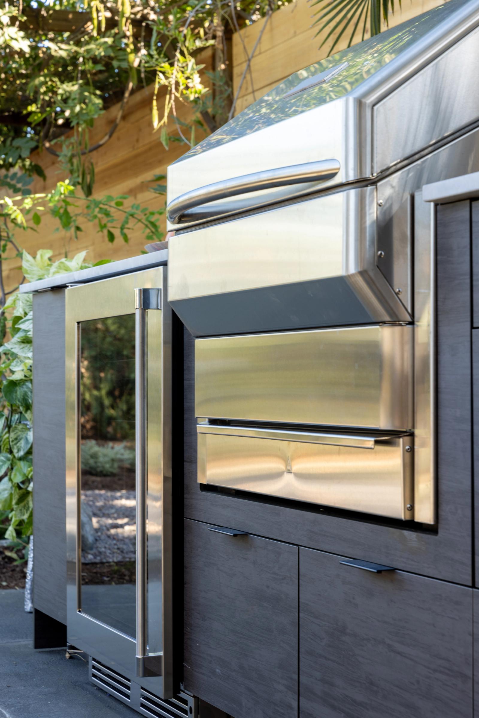 outdoor kitchen with glass door beverage fridge
