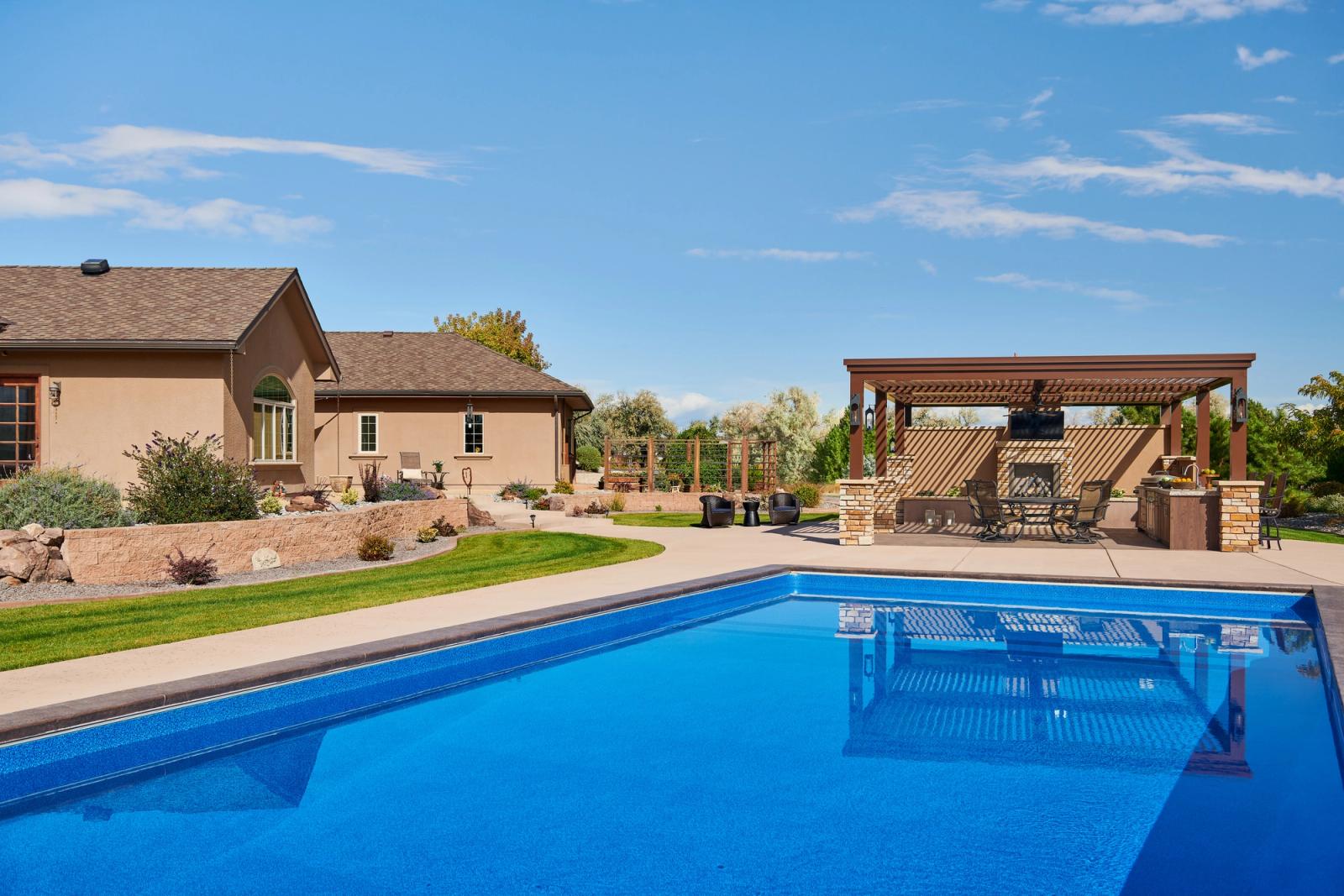 poolside outdoor kitchen under pergola in desert