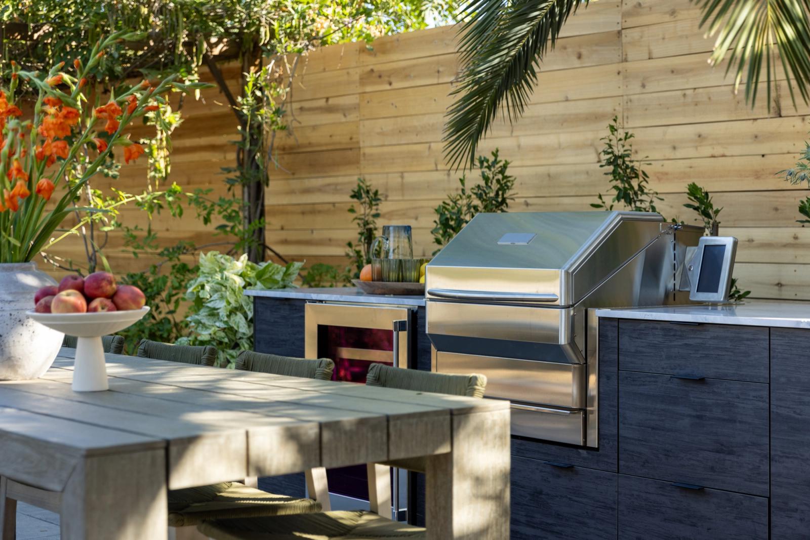 Garden kitchen in charcoal cabinetry with a built-in grill